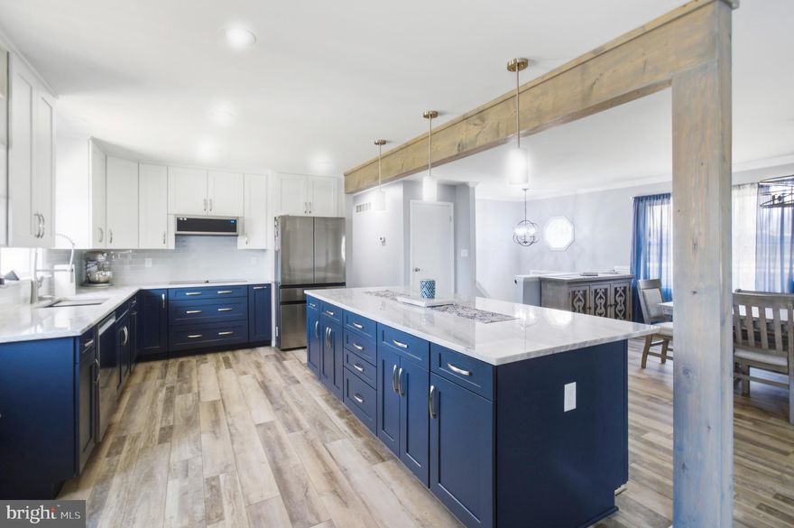 Open house Saturday 2-4pm. Stunning renovation and addition!  The gourmet kitchen was completely redesigned in 2023.  The large quartzite island has seating for 5.  Stainless steel top of the line Samsung appliances include double oven,  36" induction cooktop, wine refrigerator and two drawer French door refrigerator.  Convenient coffee and wine bar! There are 3 bedrooms and 2 full baths on the main level. The lower level is fully finished with a fourth bedroom, full bath, study and large rec. room.  New luxury vinyl plank flooring, paint and lighting throughout! Two zone HVAC system. Back yard has a large deck off the main floor and a hot tub! Roof and gutters replaced in the last 5 years.  1/3 acre corner lot in quiet Oak Bluff Community!