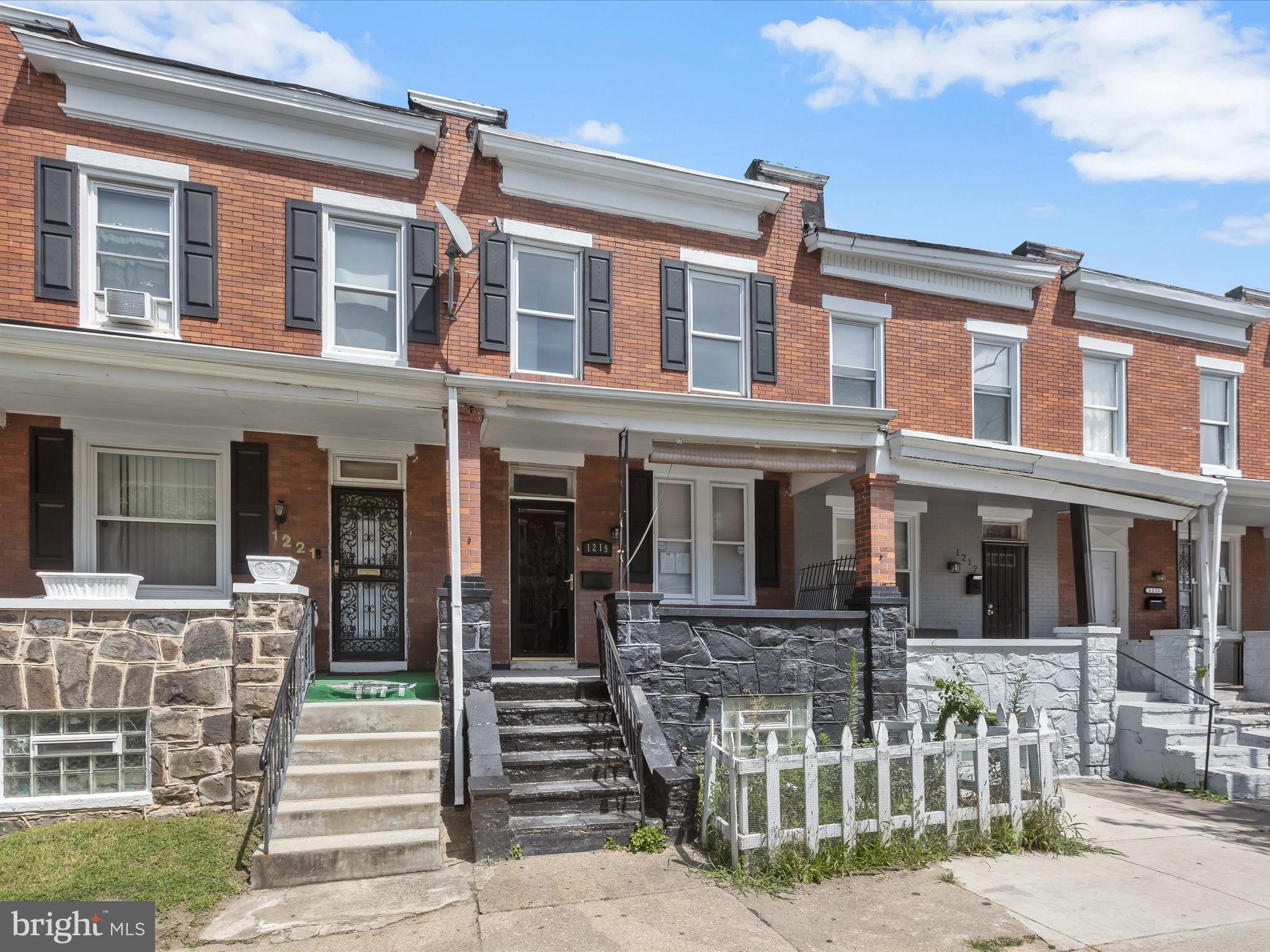 Completely renovated and full of charm, this stunning brick and stone front rowhome is move-in ready! Step onto the inviting front porch and into a beautifully designed interior featuring light hardwood floors, soaring ceilings with recessed lighting, and a decorative fireplace with classic brick surround and mantle. The open-concept main level includes spacious living and dining areas, a convenient powder room, and a gourmet kitchen equipped with stainless steel appliances, Quartz countertops, shaker-style cabinetry, and access to a fully fenced rear yard, perfect for outdoor entertaining. Upstairs, three sun-drenched bedrooms and a hall bath offer generous space, updated fixtures, and continued hardwood flooring throughout. The lower level presents endless possibilities; transform it into a media room, game room, or guest suite. Ideally located just minutes from downtown Baltimore with easy access to shopping, dining, entertainment, and major commuter routes, including I-95, US-1, and I-895. A must-see home blending modern updates with timeless appeal!