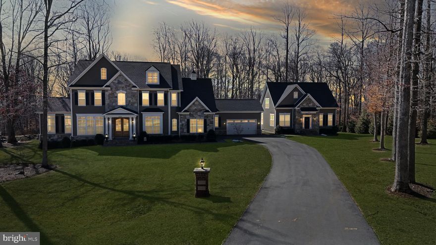 **Catered Open House Saturday, March 22nd from 3-5pm and Sunday, March 23rd from 3-5pm**This stunning Carrington-built estate is a rare and extraordinary find, offering a tranquil setting, a premium lot, and a wealth of luxurious upgrades. Located just outside Historic Downtown Leesburg, this home provides easy access to the Dulles Greenway, Leesburg Outlets, Dulles Airport, and Virginia’s renowned wineries. The main house is an architectural masterpiece, designed with both elegance and functionality in mind. The main level boasts an expansive 20-foot-wide chef’s kitchen, complete with quartz countertops, a Viking double oven, a Viking six burner cooktop, a Bosch dishwasher, an oversized and storage friendly island, and custom pull-out shelving—making it a dream for cooking, baking, and entertaining. Throughout the main level, distressed hickory engineered hardwood flooring adds warmth and sophistication, complementing the home’s refined aesthetic. The great room is an absolute showstopper, featuring a coffered ceiling, black slate framed gas fireplace, and floor-to-ceiling windows that flood the home with natural light. The inviting Keeping room and Club room, both with vaulted, beamed ceilings, add character and warmth. These rooms offer breathtaking sunrises and nighttime blinking city-light views creating spaces that feel both cozy and grand, while creating a truly mesmerizing ambiance. Additionally, a fully ADA-compliant main level living area offers a private bedroom with a walk-in closet, a full bath, a sitting room/office, and its own enclosed washer, dryer, and basin sink ensuring comfort and accessibility. Upstairs, the home offers four spacious bedrooms, each with its own private bath. The primary suite stands out as a true retreat, featuring a classically styled freestanding tub that adds a touch of luxury. A dedicated laundry room with basin sink adds convenience and functionality. The lower level is an entertainer’s dream, featuring a bedroom with a full bath, a recreational room with a wet bar and sophisticated cabinetry, an exercise room, a half bath, and extensive storage spaces. This home was designed with multi-generational living in mind. Whether you have extended family under one roof, frequent visitors, or simply need flexible living spaces, the layout offers both connection and privacy. The fully equipped Carriage home is a game-changer. The main level features a large bedroom with abundant closet space and full bath. Additionally, a well-apportioned modern kitchen with breakfast nook, a laundry area, a sizable pantry and a spacious living room adds to the uniqueness of this house. The upper level includes an expansive Primary bedroom and full bath, while the lower level provides a recreational room, a den, a full bath, and ample storage. Step outside to enjoy a charming private patio, perfect for outdoor relaxation. This home is ideal for independent living while staying close to loved ones. The exterior of the estate is just as impressive as the interior. A large Trex deck overlooks a meticulously landscaped yard, designed by Rivers Edge, featuring custom hardscaping, an irrigation system, and 41 newly planted mature trees. The property also includes plans for a 40’ x 20’ pool, offering the ability to create a private backyard retreat. A multifunctional shed with lighting and electrical is perfect for the home hobbyist and gardener. The home’s extensive Stone and Hardie Plank siding ensures lasting beauty. For those who appreciate convenience, the estate includes two separate two-car garages, providing plenty of space for vehicles and storage. Tying it all together, a pineapple-weather vane and cupola crowns the home—a timeless symbol of warmth, hospitality, and charm, making this estate as inviting as it is impressive. Every inch of this meticulously designed multi-generational estate showcases unparalleled craftsmanship, luxurious finishes, and thoughtful upgrades.