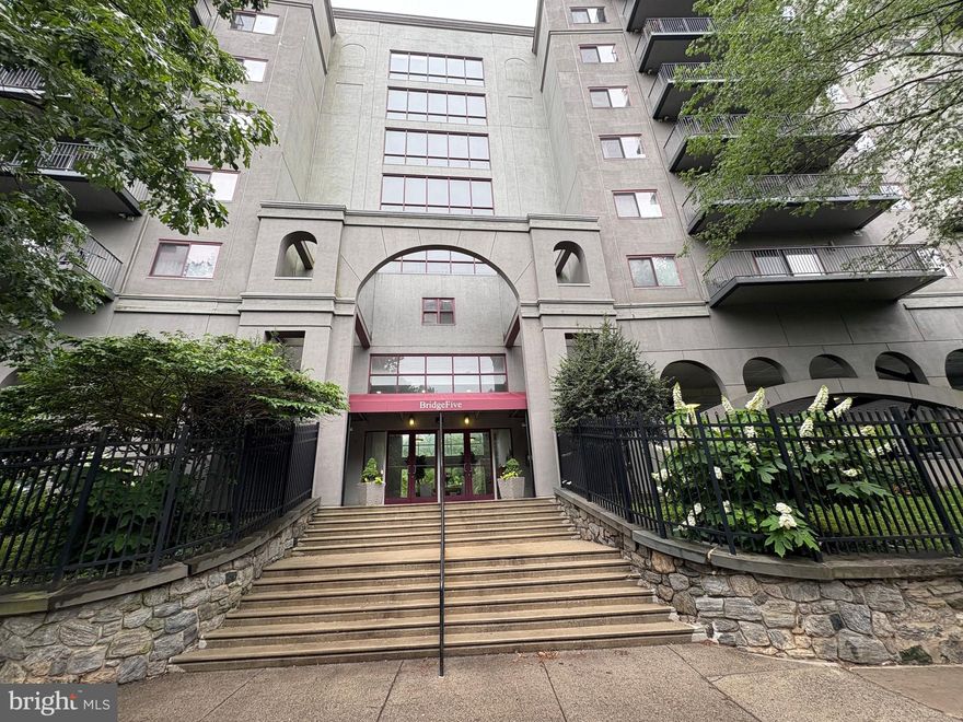 Imagine living in an updated, fully furnished condominium that combines luxury, convenience, and security in the heart of Manayunk.  Welcome to Bridge Five, where this two-bedroom, two-bathroom condo in a gated building with doorman service is ready for you!

Enter into a sun-drenched, open-concept living and dining area, showcasing exquisite wide plank hardwood floors. The chef's kitchen is a dream, featuring a breakfast bar, stylish natural wood shaker cabinets, gorgeous granite countertops, and all-new stainless steel appliances.

Find your personal retreat in one of two spacious bedrooms, thoughtfully positioned for ultimate privacy. Each includes a generous walk-in closet. One boasts a luxurious en-suite bath, while the other is conveniently adjacent to a full hall bathroom. Step out onto your private terrace for outdoor relaxation, and appreciate the ease of your in-unit washer and dryer.

At Bridge Five, your lifestyle is elevated. A fitness center on every floor makes staying active effortless, and the doorman service provides peace of mind. Commuting is streamlined with quick access to I-76 and Kelly Drive for downtown and suburban travel. Enjoy nature with the Wissahickon Trail just a short walk away.  Plus, the dynamic shops and diverse restaurants of Manayunk's Main Street are practically at your doorstep!

This isn't just a condo; it's a lifestyle. Don't miss your chance to call this exceptional Manayunk condominium home. It won't be available for long, schedule your tour today!