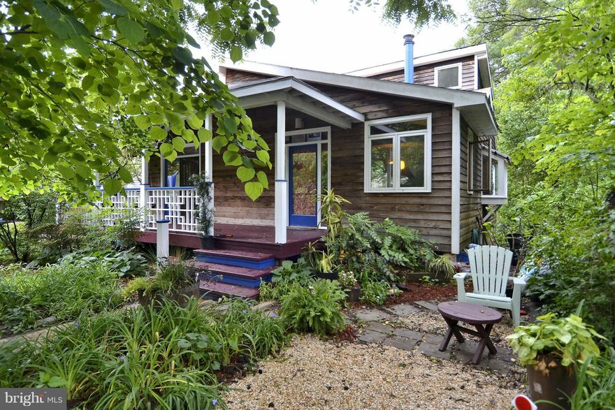 Carolina coastal home w/coveted open floor plan & inviting spaces.  Dining room, kitchen, living room with wood stove & custom maple/walnut built-ins.  upper level Master suite provides a bedroom, full bath, balcony overlooking the yard. Lower level  much opportunity for finishing. Delightful front porch and deep back yard.  Near the heart of vibrant Takoma Park, across street from Forest Park.