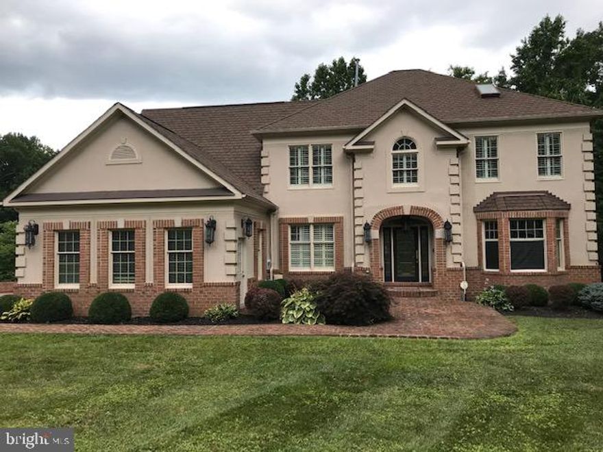 WELCOME HOME!!Beautiful custom home in custom home community.  Property is gated and privately fenced  with three car garage.  First floor has  sun room,  two story  family room with second set of stairs to upper level,  spacious formal living and dining rooms, home office, beautiful kitchen  stainless steel appliances, granite counter and backsplash, breakfast room and power room. Enter huge deck from both sun room and breakfast room.   Custom shutters throughout home.  Hardwood floors on main and lower levels. Lower level is entertainers dream!! Has theater room  with multi level seating,  large screen with projector, granite topped bar with sink, wine refrigerator, storage.  Recreation room has a pool table, wet bar with  walk out to brick patio.  LL living room has fireplace and large powder room.  Follow to the upper bedroom level.  There are two bedrooms with adjoining Jack and Jill bathroom.  Another guest  bedroom has private bathroom.  Beautiful owners suite with a morning room for your coffee, skylight, marble bathroom with separate shower and tub.  This is a home you will love to LIVE IN.  WELCOME HOME!!