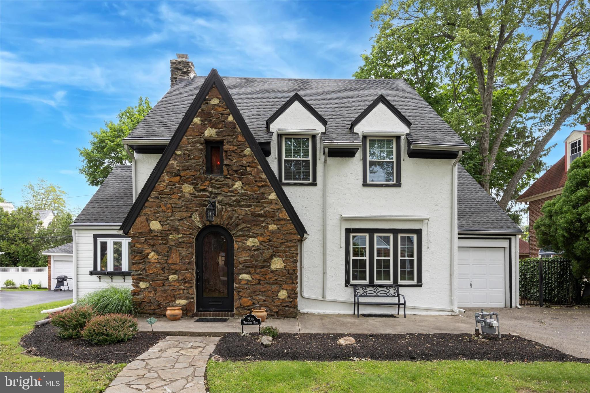 Due to the level of interest and offers in hand the sellers are asking for highest and best offers no escalation clauses by 7pm Sunday 6/8. Sellers prefer an end of July settlement date. Please include a response date of Monday 6/9. Thank you. Welcome to this beautifully maintained Tudor home, ideally situated on a picturesque, tree-lined street in the highly sought-after Drexel Park enclave of Drexel Hill. From the moment you arrive, classic architectural details and timeless curb appeal set the tone. Enter through a distinctive arched front door into a quaint vestibule with a convenient coat closet.
Step into the elegant living room, where gleaming hardwood floors, crown molding, and a stately stone fireplace create a warm and inviting atmosphere. Tucked behind the fireplace is a cozy home office, accented with exposed stone for added character.
The formal dining room is expansive and ideal for entertaining, featuring more of the pristine hardwood flooring, wainscoting, and detailed crown molding. The updated kitchen is a chef’s delight, offering granite countertops, generous cabinet space, a large custom pantry, and access to the heated, attached one-car garage.
Adjacent to the kitchen, a functional butler’s pantry adds even more storage and prep space and leads to a first-floor powder room as well as the large, recently updated deck, perfect for outdoor entertaining.
Upstairs, the second floor features a hall bath and a step-down entrance to an extraordinary dressing room and walk-in closet, complete with custom shelving and built-in storage. Three generously sized bedrooms, each with ample closet space, complete this level.
The third floor boasts a skylit full bath with stall shower, a spacious fourth bedroom with two closets (including one with an organizer system), and a fifth bedroom currently used as a studio.
The basement is unfinished yet professionally waterproofed with a perimeter system and sump pump. Here you'll find the laundry area (Speed Queen washer & dryer), updated mechanicals including a newer boiler (2021), hot water heater (2018), 200-amp electric service, and a walk-out exit to the backyard.
Throughout the home, you’ll find charming stained-glass windows, custom radiator covers, and rich woodwork that add character and warmth. The level, fenced-in yard includes a shed for extra storage.
Residents enjoy the Drexel Park Homeowners Association, a volunteer social group dedicated to preserving the neighborhood’s historic charm. This truly walkable community is just minutes from public transportation, shops, schools, and major routes—making commuting to Center City and beyond a breeze.
Thoughtfully updated for modern living, the home includes mini-split central air systems on every level, a newer roof, gutter guards and all-new vinyl replacement windows. Discover why Drexel Hill was named one of the top 5 places to move in Delaware County by Consumer Affairs—schedule your visit today!