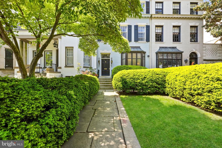 Neighborhood treasure! Spacious and bright 1931 Kalorama residence featuring grand-scale rooms, ornate architectural details, and easy driveway parking. Main level features elegant foyer with powder room and coat closet, kitchen, dining room with leaded glass windows, dramatic living room with fireplace, 12'+ ceilings, and walkout to lovely rear garden. Upstairs are four bedrooms and three full bathrooms including an expansive primary suite with fireplace, en suite bath, and dressing room. Lower level features bedroom, full bath, full kitchen, and additional storage. Romantic landscaped back garden with terrace, patio, and access to 2-car wide driveway.