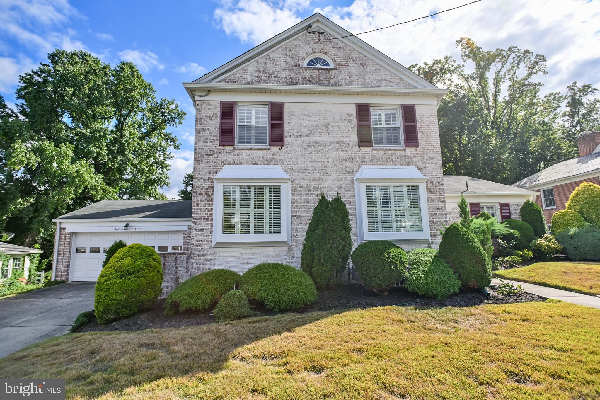 Welcome home to your 4 bedroom, 4 bath brick colonial with with in-ground pool, and 2 car garage . As you enter your new home, the first thing that you will notice is the open and airy feeling as you stand in the foyer. The spacious light-filled living room with hardwood floors, built-ins, and gas fireplace has a wonderful view of the pool and meticulously landscaped back yard through a row of windows along the rear wall. A four season sun room with floor to ceiling windows, skylight, and ceiling fan leads to a fabulous outdoor space with a bluestone patio, fenced in-ground pool, extensive landscaping, and privacy trees along the rear of the yard. The renovated kitchen, with tile floors, has granite counters, sub zero refrigerator, 40 inch cabinets and a large window that lets in tons of natural light. The formal dining room can easily accommodate a table of 8! Rounding out the first floor is a bedroom with built-ins and large closet as well as a full bathroom located in the foyer. Access to the 2 car garage is off of the kitchen so you never have to go outside in inclement weather to get into your car!
On the 2nd level you will find 3 spacious bedrooms, all with hardwood floors, excellent close space, and 2 renovated bathrooms - 1 bathroom is located in the Hallway and the 2nd is attached the primary suite. There is also access to a large floored attic from a hallway staircase that allows for ample storage.
The lower level has a large finished recreation room with a wood burning fireplace, renovated full bathroom, and an unfinished area which contains the laundry room and mechanical space. The door along the rear wall allows for access to the back yard via a concrete stairwell.
Come build your new memories at this home! It is easy to show!