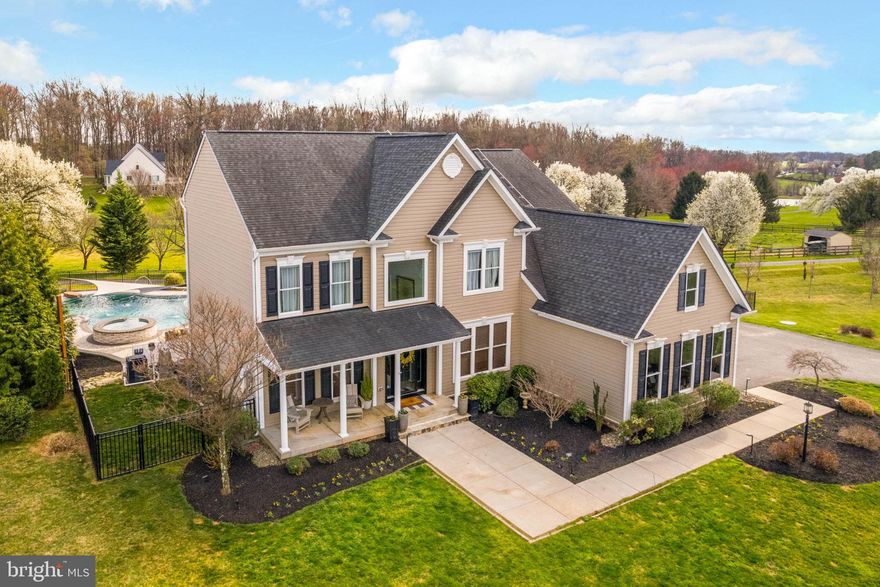 Perched in the idyllic countryside of Dayton, MD, this impressive colonial home offers a harmonious blend of elegance and comfort. Boasting 5 bedrooms, 4.5 bathrooms, and 5,464 sq ft of living space on just over an acre of land, this residence is a sanctuary of luxury. Step through the grand foyer with its soaring 2-story ceiling into the heart of the home. The gourmet kitchen is a chef's delight, featuring a range hood, center island, breakfast area, and a charming sunroom. Relax in the cozy family room with plush carpeting and a gas fireplace, perfect for evenings spent with loved ones. Entertain in style with a butler's pantry leading to the formal dining room, highlighted by a tray ceiling. The main level office provides the ideal space for remote work or study. Retreat to the primary bedroom with its own ensuite and spacious walk-in closets. Three additional bedrooms and a bonus room that can easily be converted to a fifth bedroom complete the upper level, offering flexibility for living arrangements. The fully finished basement is the ultimate entertaining space, featuring a walkout, an extra room for a workout area or home office, and ample storage. Outside, a multi-level deck with a conversation pit, stone patio, fire pit area, cabana, and an inviting in-ground pool await your enjoyment. Surrounded by a fenced rear yard and a vast side yard, this home offers a private haven with the added tranquility of backing to a picturesque horse farm. The landscape is adorned with beautiful specimen trees, creating a serene backdrop for outdoor relaxation. Discover a harmonious blend of luxury living and natural beauty in this splendid Dayton, MD home.