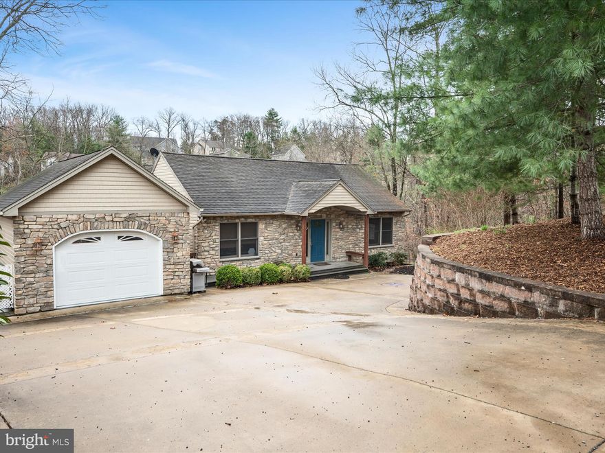 Stunning Waterfront Retreat Near Beach II 
Discover this magnificent multi-level contemporary home nestled on a peaceful cove off the main body of the 240-acre Lake Holiday. With breathtaking water views and direct lake access, this unique property features a private floating dock and a sun deck—perfect for relaxing by the water.

Boasting four bedrooms and three full baths, this home offers a spacious open floor plan designed for both comfort and entertainment. The sunken great room impresses with its 18-foot cathedral ceiling, a soaring stone-front wood-burning fireplace, and elegant American cherry flooring. The stylish kitchen is beautifully appointed with granite countertops, a tile floor, a breakfast bar, and a dining area.

Outdoor living spaces abound, providing plenty of opportunities to enjoy the stunning surroundings. A 14x12 screened porch offers a shaded retreat with views of the lake, while the expansive 25x15 covered deck includes a designated platform and electricity, ready for a hot tub. An additional 18x11 side deck presents a perfect vantage point for taking in the tranquil lake views.

The main level features a bedroom and full bath, while the expansive two-level master suite offers a private sitting area and en-suite bath. The lower levels host a spacious family room, two additional bedrooms, a full bath, and a laundry room with a washer and dryer (less than two years old).

This home also includes a one-car garage with a workshop area, electricity, and water, as well as a private level parking area conveniently located at the front door. An outdoor shower adds to the convenience of lakeside living. Additional storage is available with pull-down attic steps in the garage and a remote-controlled attic hatch near the master bedroom stairs. The concrete driveway features a decorative medallion, complementing the charming stone façade and a welcoming 5x56 front porch that connects to the garage.

Located just moments from Beach II, this home is designed for lakefront living at its finest. The dock and steps have been recently stained, making them ready for endless summer fun. Don't miss this opportunity to own a truly one-of-a-kind waterfront retreat!