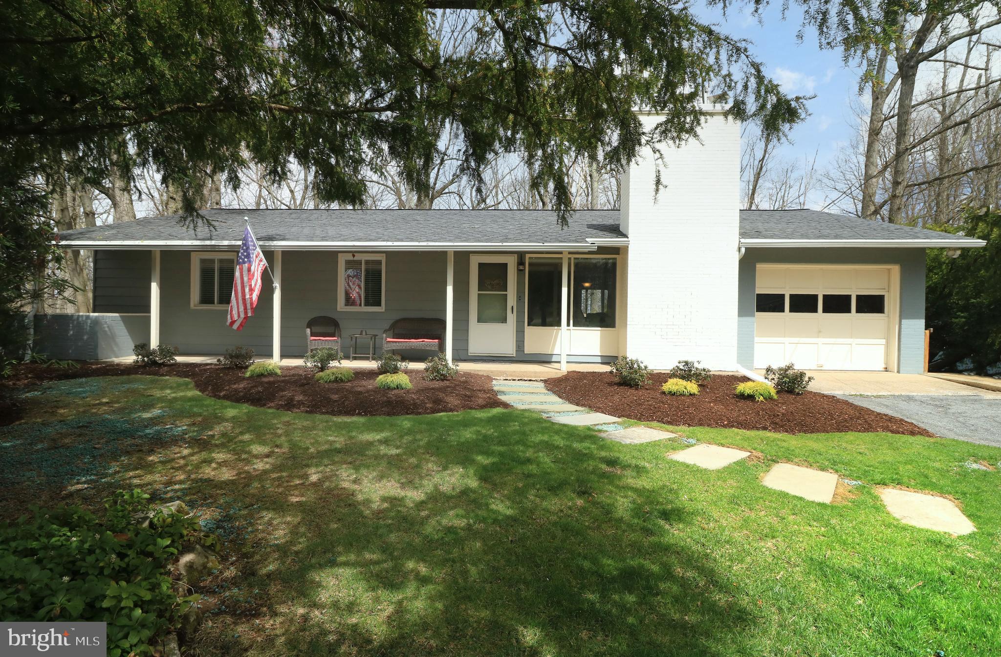 Lovely and rare four bedroom and two full bath ranch home in the well-liked Park Forest Village neighborhood! Enjoy beautiful landscaping, trees and grounds from your covered front porch, from the elevated rear deck, or from the backyard patio. Enter into sprawling hardwood floors throughout the home and an open floorplan, a rarity for these ranchers in Park Forest. The front living room boasts a large window and a wood-burning fireplace, while the adjacent dining room features a slider to the rear deck and is open to the remodeled kitchen, complete with hickory cabinets and an island. With four bedrooms and two full baths, including a primary bath, you have lots of options for bedrooms, offices, guest rooms, and hobby rooms. Downstairs you'll find a completely open and ready to be finished walk-out basement featuring several windows, two walk-outs, and plumbing for another bathroom. You'll appreciate a newer HVAC system, newer electric panel, and some newer appliances, as well as the one car garage. Close to a bus stop, parks, schools, the pool, shopping, restaurants, and not far from Penn State's Campus and downtown State College. A great place for the price!