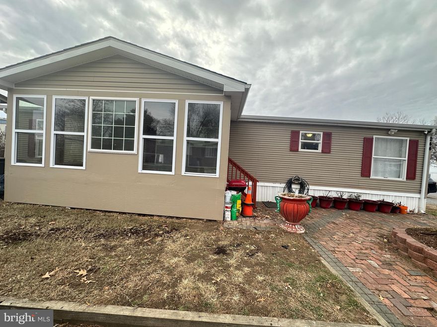 Beautiful double-wide mobile home.  Features 3 large bedrooms, 2 full baths, one  with a walk-in closet.  Home remodeled in 2021.  Open living concept,  a  stunning kitchen with quartz countertops .  Gorgeous hardwood floors in the living room/kitchen area, and lvp flooring in the bedrooms.   New HVAC system, new water heater, four year old roof.  Enclosed front porch.    Home ready for new owner.  Don't want to miss this one !