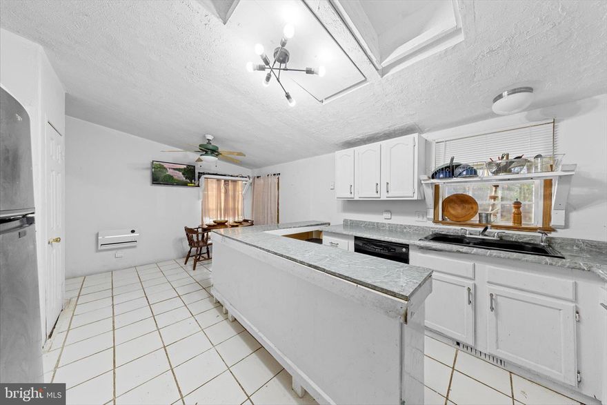 Tucked among mature trees just off Butler Branch Road in Seaford, Delaware, this nearly one-acre property offers a rare opportunity to create something truly special. Surrounded by nature and set back from the road, this diamond-in-the-rough home is waiting for the right buyer with vision to transform it into a peaceful retreat of their own. The existing 3-bedroom, 2-bath mobile home is thoughtfully positioned on the property to maximize privacy and yard space. Inside, laminate flooring runs throughout, visually unifying the spaces and enhancing the sense of openness. The traditional split floor plan places the primary bedroom with its ensuite bath on one side of the home, while two additional bedrooms and a shared hall bath are located on the opposite side, ideal for both privacy and functionality. At the heart of the home, the main living area flows into an eat-in kitchen featuring generous counter space, a wrap-around island, and a dining area filled with natural light and tranquil woodland views. An additional powder bath off the laundry room, along with direct access to the rear yard, completes the interior layout.
Step outside to discover one of the property’s most captivating features, the backyard opens to a canopy of mature trees and overlooks Butler Mill Branch, where gently flowing waters create a serene natural backdrop right beyond your own yard.
Being sold As-Is, this property presents an exciting opportunity for buyers looking to invest, reimagine, or rebuild in a peaceful setting with abundant potential. How will you make this hidden gem your ultimate home retreat?