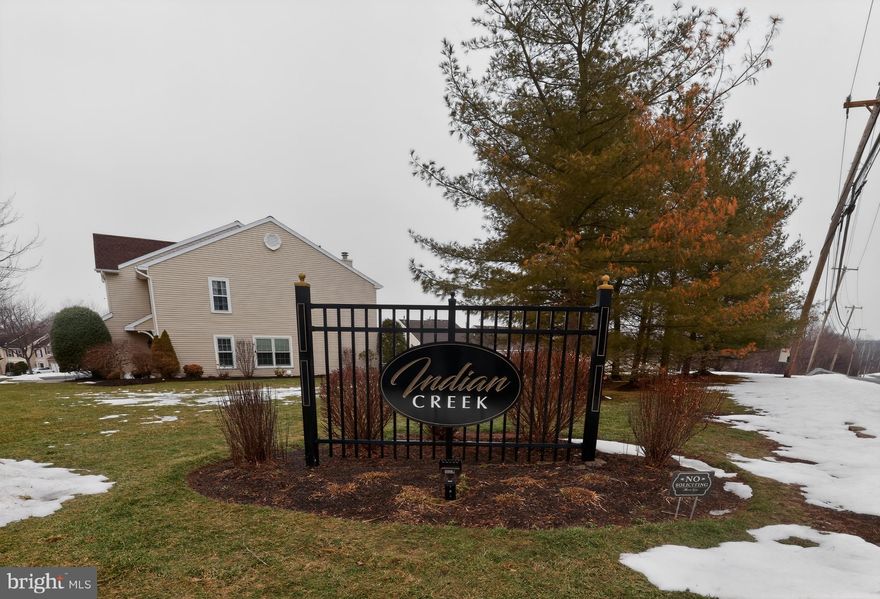 Welcome to this beautifully maintained end-unit home in the desirable Indian Creek community, situated on a premium private cul-de-sac lot with peaceful wooded views and a nearby stream. The welcoming two-story foyer with hardwood flooring opens to the formal living and dining rooms, creating a bright and inviting first impression. The cozy family room features a sliding door to the deck, overlooking a serene landscape with stairs leading down to the patio and daylight walk-out basement. The kitchen is clean and bright with tile backsplash, built-in microwave, dishwasher, large pantry, and breakfast nook. Upstairs, the spacious primary bedroom offers vaulted ceilings, dual walk-in closets, and a full bath with soaking tub, separate shower, and extended vanity, along with two additional generously sized bedrooms and a full hall bath. The surprisingly large finished basement provides great entertainment space plus a sizable utility and storage area with washer and dryer. Recent updates include a new roof (2020) and additional roof improvements and a new water heater completed in 2025. The community offers sidewalks and a playground, and the home is conveniently located near shopping, dining, Route 422, Town Center, and within the Spring-Ford Area School District.