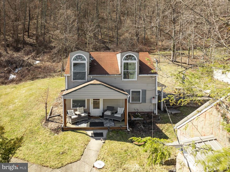 Nestled in the heart of Deep Creek Lake, this charming and fully furnished cottage offers the perfect blend of relaxation and investment potential. Recently remodeled, it features a brand-new modern kitchen that seamlessly opens to the living area, refinished wood floors, and upgraded electric,. The light and airy upstairs space enhances the home's inviting atmosphere, complemented by large windows, an energy-efficient gas stove, and an open floor plan. Just steps from boat and jet ski rentals and the beloved Lakeside Creamery, this two-bedroom retreat is a sought-after rental property. Outside, enjoy a spacious patio with an outdoor fireplace, perfect for cozy evenings, while the storage shed provides ample space for all your lake toys. Whether you're soaking up the summer sun on the water or hitting the slopes at Wisp Resort in the winter, this home offers year-round recreation.