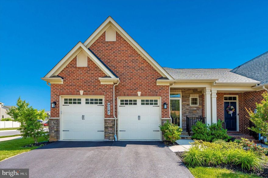 OPEN HOUSE CANCELLED - UNDER CONTRACT  Do you want a brand-new house without the hassle of building one?  Here is an opportunity to purchase one of the highly sought-after 55+ Senior Living Villas at Boxwood in Urbana.   This premium lot already has all of the greatest upgrades.  As a second home for the current owners, it has been lightly lived in.  The lovely brick and stone front entrance welcomes you.  As you enter, you will be captivated by the premium options included in these tastefully chosen selections.   The open-concept kitchen, dining room, and living room with expansive coffered ceiling and fireplace flow together seamlessly to a peaceful retreat on the back deck on which you can enjoy the sunset on this premium lot backing to greenspace.   Features such as the carriage-style two-car garage, the exterior Tamko 30-year architectural shingles, and professionally upgraded landscaping will allow you to enjoy a low-maintenance future.  The 3" engineered hardwood floors throughout the main floor, oversized windows with custom shades (that convey), and 9-foot ceilings bring it all together.   The professionally designed kitchen includes high-end cabinetry, dovetailed drawers, interior organizational systems, a 5-burner gas cooktop, a built-in microwave and convection wall oven, a spacious kitchen island for entertaining, a separate pantry, and a classy wine closet.   The owner's suite is just steps away on the main floor and boasts its own tray ceilings, luxurious owner's bath with elevated vanities and granite top, frameless walk-in shower, and walk-in closet.  For total main-floor living,  the laundry room is right off the kitchen!  Upstairs is another living area that includes shared open living space, two large bedrooms, a full bath with double sinks and granite, and an inviting bright office with windows and built-in shelving opening through French-style glass doors for the perfect private but not-too-private home office.  A great storage room completes the second floor.  A French door off the kitchen takes you to the walk-out finished basement, which provides for a multitude of uses.   The sizeable recreation room has bumped-out spaces for exercise, media, dining, or games with additional storage areas and a third full bathroom.  Even the basement has outside entertaining with pavers on the patio overlooking the green space for grilling and outdoor fun!  Energy efficiency in every room including tankless gas water heater, high-efficiency gas furnace, 14-seer air conditioner, R-49 attic insulation, programmable thermostat, and insulated windows with efficient glazing.  The Villages of Urbana is loaded with amenities; enjoy the pool, trails to walk, parks and nature.  Come see what this gorgeous property can do for you!  Why buy new and live in the middle of a construction zone?