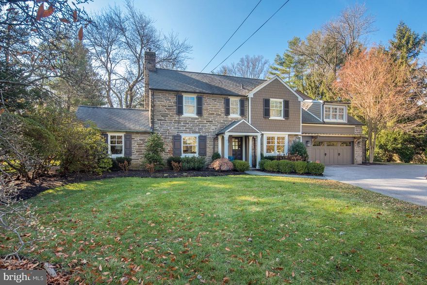 A classic, modernized beauty in desirable Northside Bryn Mawr featuring 5 bedrooms, 4.2 bath & finely-designed living space, set on picturesque landscaped grounds. This elegant center hall colonial on a level .77 acre corner lot has been impeccably updated, perfect for the discerning family. Many recent improvements include new Hardy cement board siding complementing the charming stone exterior, 42 new Kolbe windows inviting generous light inside, refinished random-width hardwood floors throughout, a brand new chef s dream kitchen, thoughtful master suite extension, fully renovated baths, plus a new natural gas heat system, new lawn irrigation & new natural gas generator! The gracious entry foyer welcomes your arrival, with a coat closet & powder room located down the hall. Entertaining is divine in the spacious living room at left presenting a wood-burning fireplace, pictures windows, property views & access to the expanded flagstone terrace. A lovely library/den/office with built-ins adjoins & provides a quiet place to read or work. To the foyer s right is the formal dining room boasting a wide opening to the stunning renovated kitchen, the heart of the home. Here, new cabinetry, new quartz countertops & island, and new appliances including a 6-burner Wolf range with griddle, double oven, built-in fridge & microwave and ice maker inspire culinary creations. Connected is a convenient mudroom with coat closet, doggie bath & door to the 2-car attached garage, part of the expansion. Also aside the kitchen is a large bright open family room with a gas-burning fireplace, triple doors to the rear patio & yard, and 2nd powder room right nearby. Upstairs sits a vaulted master suite illuminated by windows on triple exposures, with 2 walk-in closets. Refresh in the gorgeous new marble master spa bath with a soaking tub, oversized shower and double sinks. Further along the hall is a laundry room, 3 additional bedrooms, an updated hall bath, and 5th bedroom with a walk-in closet & redone en-suite. A finished basement offers added storage. Ideally situated in the award-winning Lower Merion school district, close to all amenities.