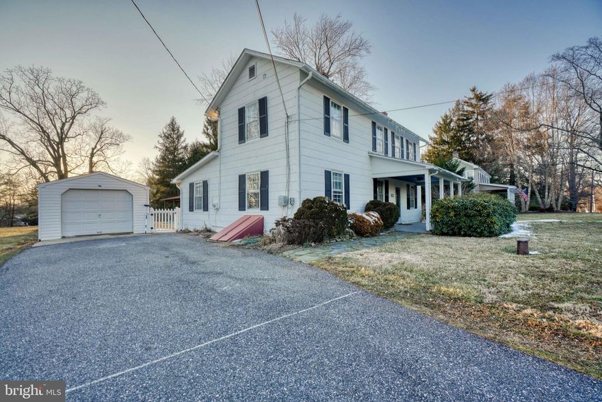 CHARMING!!  Circa 1900 farmhouse is situated on a half acre with beautiful views, a barn and detached garage!   Enjoy coffee on the front porch and walk into a lovely interior with hardwood flooring, exposed brick, vaulted ceilings. powder room and a main floor bedroom.   In the kitchen you'll find plenty of counter space and a sweet sitting area.  The sink is huge and the window above overlooks the back deck area.  There is a lovely dining room with space for a large table and windows all around.  The living room is off of the dining area and is adorned with the exposed brick, wood beams and delightful staircase.  The upper level features 2 bedrooms, a full bath and laundry area.  Make your dream of owning a beautiful farmhouse your reality!