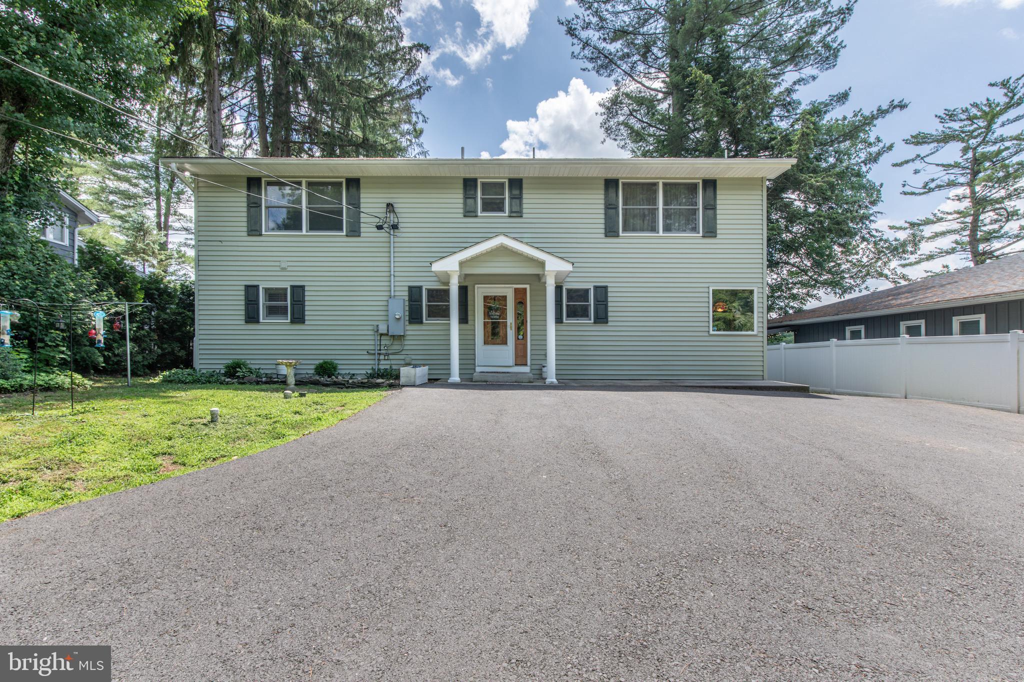 Lakeside Luxury at 5194 S Hamilton Dr, Saylorsburg, PA 18353 3-5 Beds | 2 Baths | 3,100+ Sq Ft | 0.73 Acres | 73 Ft of Lake Frontage | Sauna | Stroudsburg SD Discover your dream home on the peaceful shores of Saylors Lake Fishing Association! This expanded and beautifully renovated lakefront retreat offers over 3,100 sq ft of refined living on nearly 3/4 of an acre with stunning panoramic views. Step into a sun-drenched open-concept layout featuring vaulted ceilings, new wood and tile floors, and an original stone fireplace with a gas insert. The custom new wood-floored kitchen, that boasts granite countertops, a central island, a cozy breakfast nook, and a banquette for extra seating and charm. Enjoy the ease of main-floor living with a spacious primary suite and laundry room on the first level. Upstairs, a sunny enclosed porch with private upper-level deck is perfect for lounging or tanning. The flexible 3-5 bedroom layout offers room for guests, office, or creative space. OUTSIDE SHOWER and the Original Vintage Spring House Year-round comfort is ensured with many mechanical updates: new furnace, hot water heater, central air, oil tank, paint, flooring, kitchen and paved driveway. Unwind in your own sauna, relax on the covered porch, or gather around the lakeside fire pit under the stars. The dual-level deck overlooks your private 73 feet of lake frontage, and the walk-out basement offers storage for your canoe, kayak, or fishing gear. Located in the Stroudsburg School District with quick access to Routes 33 & 80, this home is minutes from skiing, hiking, and shops—yet feels like a secluded resort. Your lakefront lifestyle starts here. Don't miss this rare find!