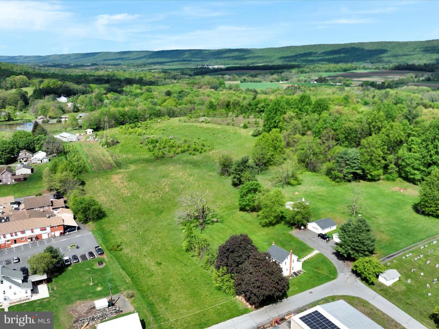 LAND! LAND! LAND!    Property stretches from Spruce Street to Church Road.   This beautiful 15.2 -acre parcel  in Blue Mountain School District offers a combination of open space & natural woodland with public sewer conveniently running along Spruce Street and the added benefit of reduced taxes through the Clean & Green program!!  A well is required - no access to public water.   Options & Dreams abound.   Whether you are commuting or just running errands, you'll appreciate the balance of convenience  & accessibility.  The possible access to public sewer and the  cleared topography may allow for future subdivision (subject to township approvals of course)  making this a smart long-term investment opportunity!  A PP&L  easement is in place.   Call today for more information.  OFFER HAS BEEN RECEIVED!  HIGHEST & BEST DUE BY 3PM TOMORROW.