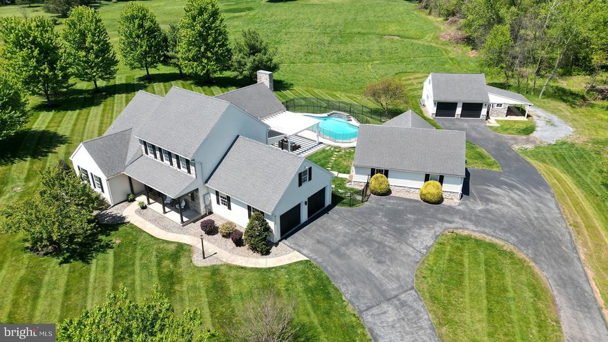 The Ultimate Private Compound: 17.5-Acre Custom Estate
Palmyra, South Londonderry Township | 10 Minutes to Hershey Med | Clean & Green Enrolled
Experience exceptional privacy and refined country living in this custom estate by Shaffer & Sons Builders. Set nearly 500 yards off the road via a private lane, this 17.54-acre agriculturally zoned property offers a rare blend of modern design, usable land, and meaningful tax advantages through Pennsylvania’s Clean & Green program.
Ideally positioned just minutes from Penn State Health Hershey Medical Center and within the top-ranked Palmyra Area School District (#1 in the county, #55 statewide per Niche 2026), the location balances convenience with true seclusion.
The main residence spans approximately 4,100 finished square feet across three levels, highlighted by soaring 13–14 ft vaulted ceilings with cedar tongue-and-groove finishes, custom beams, and striking floor-to-ceiling stone fireplaces. The fully redesigned kitchen features quartz countertops, floor-to-ceiling cabinetry, and a bold waterfall-edge island, complemented by premium appliances including a propane range.
A main-level primary suite captures sweeping views and includes a modernized bath with dual vanities and space for a soaking tub. Upstairs, two bedrooms and a flexible reading den offer the option for a fourth bedroom, while a large bonus room above the garage provides additional finished space for guests or storage. The finished basement adds another 800 sq. ft. of flexible entertainment and recreation space, ideal for a home theater, gym, or game room.
The outdoor setting is designed for both relaxation and entertaining, centered around a heated saltwater pool with waterfall features and color-changing LED lighting, complete with a removable child safety fence. A 700 sq. ft. fully self-contained guest house with kitchen, bedroom, and laundry offers ideal accommodations for extended guests or multi-generational living. A detached 24x30 insulated garage/workshop with 100-amp service and floor drains adds further utility.
The land itself is a standout—fully agriculturally zoned and highly usable—featuring an established food plot, multiple tree stands, ATV and walking trails, and natural streams bordering both sides of the property, creating a true private retreat rich with wildlife.
Additional highlights include 400-amp electrical service, Verizon Fios availability, an owned 500-gallon propane tank, and generator pre-wiring.
Properties offering this level of acreage, flexibility, tax advantages, and proximity to Hershey are rarely available. Schedule your private showing today.