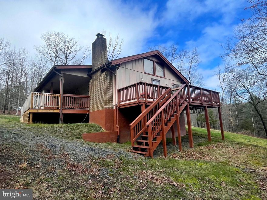 Discover your idyllic mountain retreat in this charming 2-bedroom, 2-bathroom home nestled on a quiet  street in Shenandoah Ski and Hunt Estates, just moments away from Bryce Resort. Situated on a spacious 2-acre lot, this property offers the perfect blend of tranquility and convenience. Embrace the beauty of nature with a mixture of open green space and wooded surroundings.

As you step inside from the covered front porch you will find single-level living at its finest, featuring an open-concept layout encompassing the living and kitchen areas, complete with vaulted, exposed beam ceilings, 2 bedrooms and 2 full bathrooms. Cozy up by the living room fireplace equipped with a pellet stove insert, ensuring warmth during chilly mountain evenings. Or, step outside to enjoy picturesque views from the inviting deck, accessible from the living room.  Just off the primary bedroom with ensuite bathroom, you will find convenience meets functionality with a dedicated laundry/mudroom that is easily accessed from a second entrance under the covered porch, ideal dropping off post-hike or ski adventure gear. 

A quick walk down the stairs off the side deck, you will find the unfinished walkout basement that is awaiting your creativity.  This space offers an additional approximately 882sqft with endless possibilities for your own customization such as additional living space, storage, or a home gym.

Schedule your tour today and take the next step toward owning your own mountain retreat.

*Interior photos to be taken 4/8