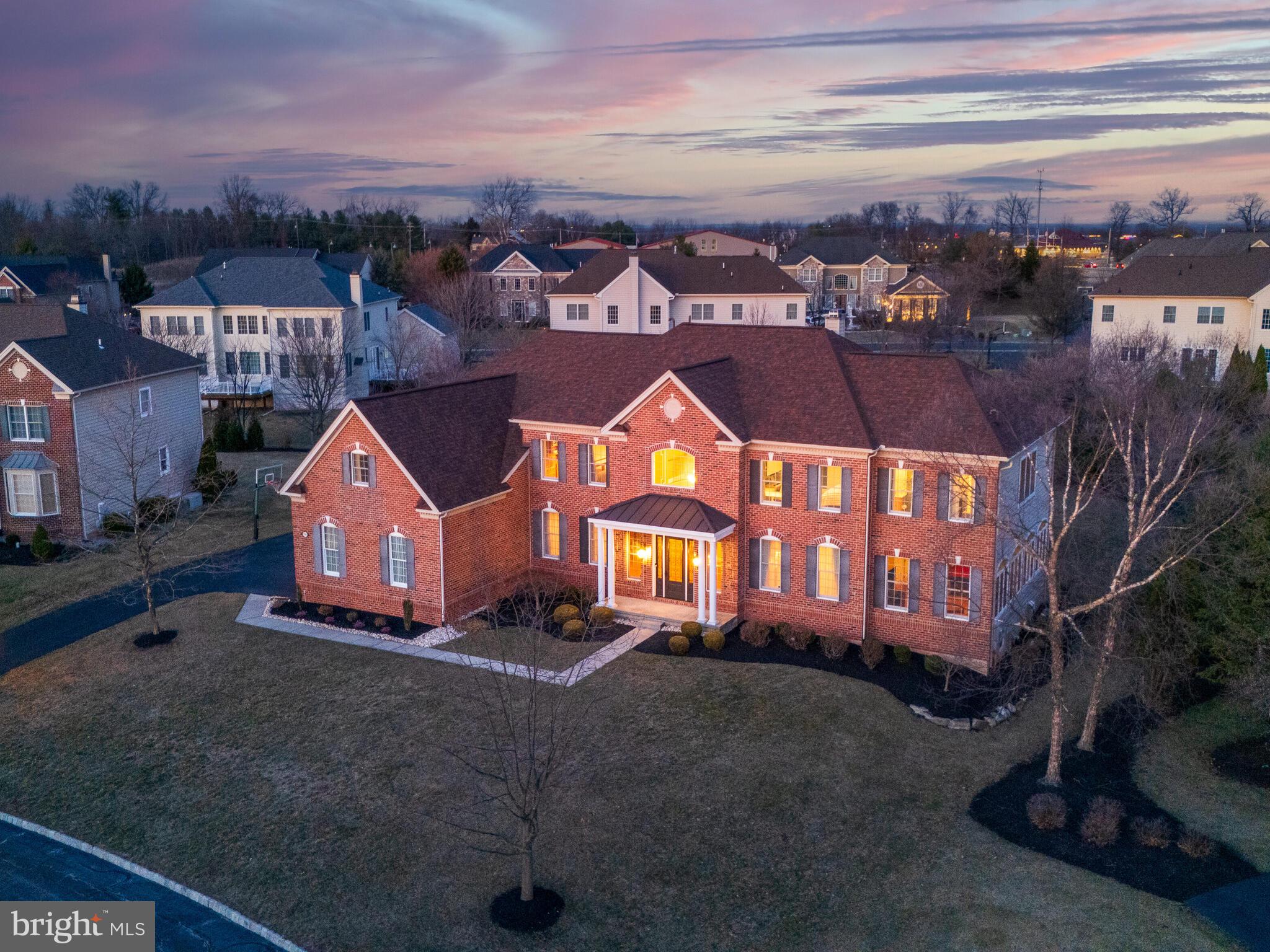 Welcome to 206 Rock Dove Lane, nestled in the prestigious “Masters” section of the gated Rivercrest Country Club community! This luxurious property has unique features and upgrades that elevate everyday living. With 6,057 above ground sq ft, this home includes 5 bedrooms, 4.5 bathrooms. The seller has invested over $150,000 in upgrades, post construction: Roof (2021); Replaced two HVAC units/systems (2023/2024);Installed new Water Heater, Installed new composite deck (2018); Installed new exterior doors (with built-in sliding blinds), leading out to the deck from the kitchen; Installed custom cabinets, granite counters, new sink in the laundry room; Installed new front door; Installed custom, built-in storage cubbies, coat/backpack hooks & seating bench; Custom lighting and millwork installed in all rooms throughout main and upper levels; Windows have been tinted in the conservatory and the wall of windows in the room above the conservatory to protect the wood floors and the furniture; Installed ceiling fans in every room on the upper level; Invested in planting established evergreens around the perimeter of the backyard for added privacy; Installed custom, decorative iron stair spindles on all three stair cases. Upon entering the home through the front door your friends and family will immediately notice the breathtaking two-story foyer with custom mill work and a dramatic double staircase. The formal dining room & living rooms, both with tray ceilings, crown molding, flank the elegant grand foyer. The heart of the home features a gourmet kitchen and is equipped with dark wood cabinets, high-end commercial grade appliances, granite countertops, an oversized island, and a large breakfast area with views of the private back yard. The large sunroom(Naples Room), surrounded with walls of windows, is also part of the kitchen area and offers a relaxing space for entertaining family and friends and a set of doors out to the deck. There is a desk area in the kitchen for doing homework and a large pantry with plenty of storage. The family room off the kitchen has 23' coffered ceilings with a wall of windows & cozy natural gas fireplace and a second staircase to the upper level. A large side conservatory, with a separate zone for heating and air conditioning, boasts enough room for a private home office, or a game room, etc.. An upgraded laundry room and adjacent mudroom offers abundant storage and convenience adjacent to the three car garage. The private, large office and half bath complete the first floor. Upstairs, the primary suite features a spa-like en suite bathroom with two separate water closets, two separate sink areas, a large soaking tub and a large glass enclosed walk in shower. There is a spacious sitting area, elegant tray ceilings, and an oversized walk-in closet. Four additional well-appointed bedrooms provide ample space, each with generous closet storage and three bedrooms with their own ensuite bathrooms and bedrooms 4 and 5 share a jack and jill bathroom. The unfinished basement is the entire footprint of the structure and is plumbed for a full bath and features 9 foot ceilings. Located in Spring-Ford school district, Rivercrest offers private walking trails, a community clubhouse with a gym and pool, and comprehensive HOA services, ensuring a low-maintenance, upscale lifestyle. 206 Rock Dove Lane is an invitation to experience luxury, convenience, and unparalleled craftsmanship in a beautiful golf course community. Welcome home!