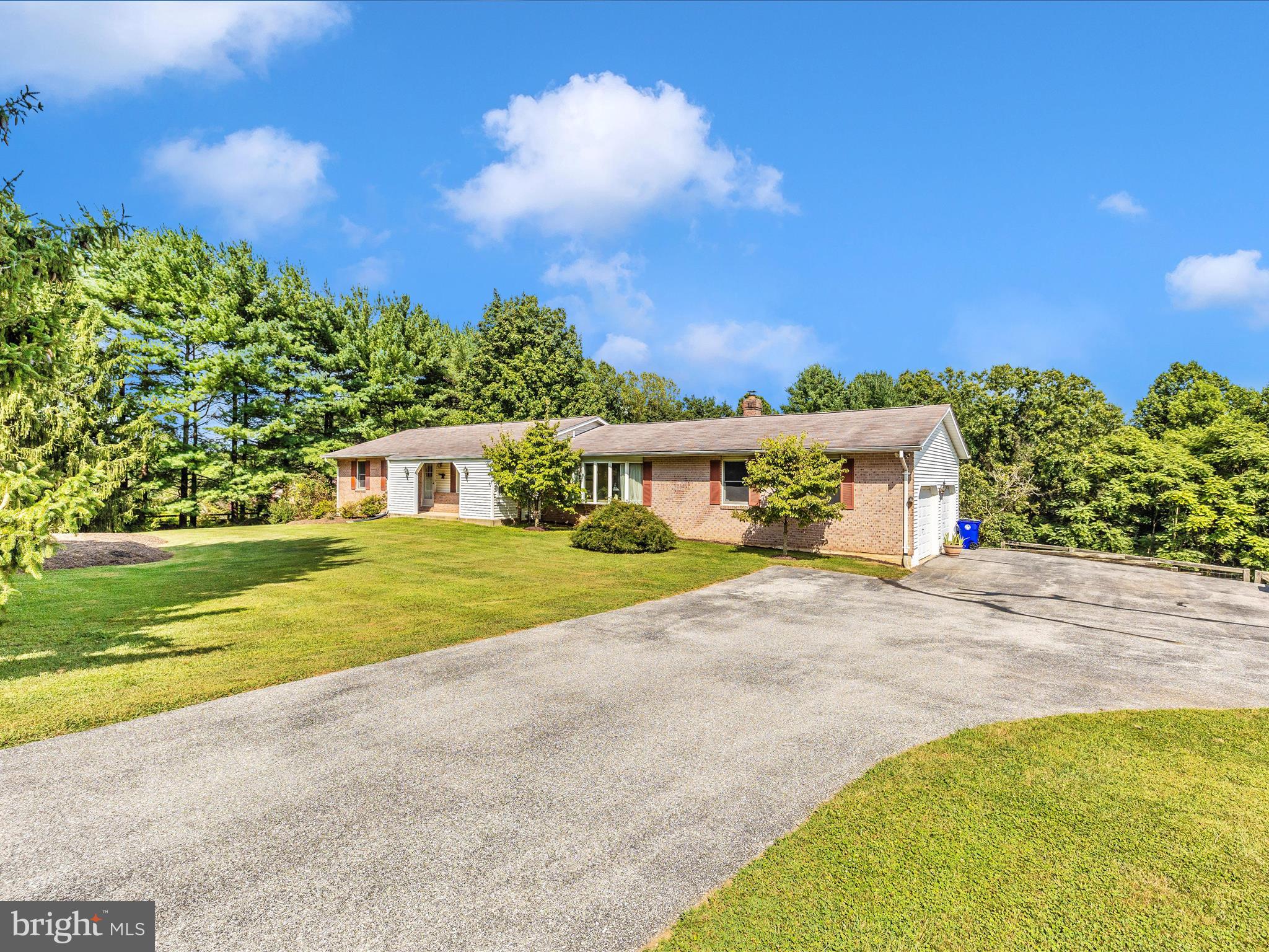 Tucked away on a private, peaceful 4+ acre lot backing to mature trees, this well-maintained brick rancher offers the perfect balance of comfort and tranquility. Imagine sipping your morning coffee on the expansive deck, accessible from both the primary bedroom and the family room, while taking in the sights and sounds of nature. Inside, a Vermont Casting wood stove on the main level and a Harmon wood stove downstairs create a warm, inviting atmosphere all winter long. The lower level also offers a potential third bedroom, adding flexibility for guests, a home office, or a hobby space. You can also revert back the second bedroom to be 2 again providing a 3-bedroom home. You'll love the oversized 2-car garage. Recent updates bring peace of mind, including HVAC (2021), a hot water heater (2024), newer sliding glass doors, fresh paint, and new porch windows. With no HOA, you’re free to fully enjoy the property your way—whether that means gardening, entertaining, or simply soaking in the quiet beauty of your surroundings. Schedule your showing today!!