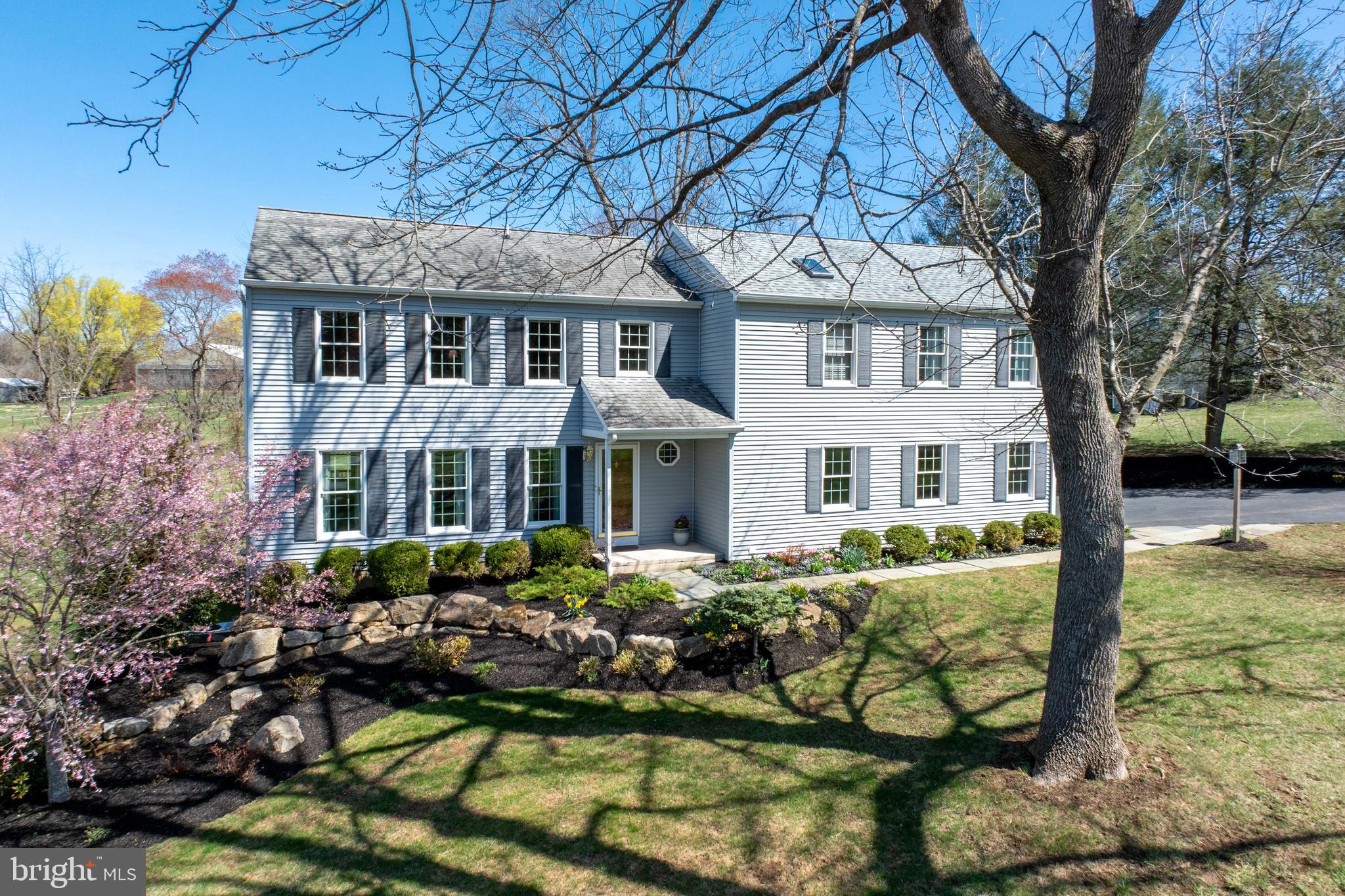 Nestled on a serene one-acre lot within the sought-after Downingtown East School District, this beautifully expanded 4-bedroom, 3.5-bathroom home has been meticulously maintained and thoughtfully updated by its original owner. A stunning family room addition serves as the heart of the home, featuring a floor-to-ceiling stone gas fireplace, rich hardwood floors, and an Andersen French door leading to a spacious TimberTech deck—perfect for relaxing or entertaining. The kitchen has been expertly remodeled by a reputable builder, showcasing Honey Brook Custom Cabinets, exquisite granite countertops, and high-end appliances, including a Wolf 5-burner gas cooktop, Bosch electric oven, microwave, and refrigerator, as well as a Miele dishwasher with a panel that blends seamlessly into the cabinetry. Additional features include a tiled backsplash, built-in wall cabinet with hidden outlets, an instant hot water faucet with a filter, and recessed lighting with multiple switches. Step through the Andersen French door with transom window to the deck, where you can enjoy your morning coffee at the built-in bar or host gatherings with friends and family. The main level also offers a formal living room, dining room, an updated powder room with a granite-topped vanity, and laundry room with a closet, cabinets, and access to the 2-car garage with an alcove for extra storage space and side door to a stone walkway. Upstairs, the impressive primary suite addition features a vaulted ceiling with a fan, walk-in closet, linen closet, and a spacious private bath with a jetted corner tub, double-bowl vanity with a Tere-Stone top, and a tiled shower. Down the hall, two bedrooms share a hall bath with a tub, tiled floor and linen closet, while the fourth bedroom boasts a walk-in closet and an updated private en-suite bathroom. The unfinished basement provides excellent storage space and includes a convenient walkout door to the side yard, making it easy to move items in and out. The beautifully landscaped lot offers plenty of space for outdoor activities and features fruit trees, including apple and pear, along with blueberry bushes protected by netting. The property also boasts lush landscaping with trees and flowering plants that provide seasonal beauty year-round and an invisible fence for pets. Additional upgrades include brand new hot water heater, Andersen windows, vinyl siding, driveway and garage doors. Located just minutes from the PA Turnpike, Route 100, and Marsh Creek State Park, this home combines a fantastic floor plan, a picturesque setting and convenient location—all within the award-winning Downingtown East School District.