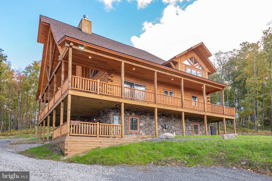 Built for slow mornings and bold sunsets, Hilltop Cottage delivers mountain luxury without the fluff. Vaulted ceilings. Fieldstone fireplaces. A wide-open layout that draws you straight to the view. This newer log home was finished in late 2023 and packs six bedrooms, seven baths, and every cozy corner your crew could need. The kitchen nails the balance—modern, but warm—stainless steel, granite, and handcrafted woodwork. The great room spills into two levels of wraparound decks, with a front prow made for coffee and firelight. Downstairs brings the fun with a second hangout zone and a walk-out patio. Dual primary suites. Game-ready bunk rooms. A loft that overlooks it all. Outside, you’ve got a fire pit, hot tub, and even a Tesla charger. Turnkey and fully furnished. Perched in North Camp Ridge with unreal western views—just minutes to Wisp. Whether it’s a rental beast or your private retreat, this one’s built to last.