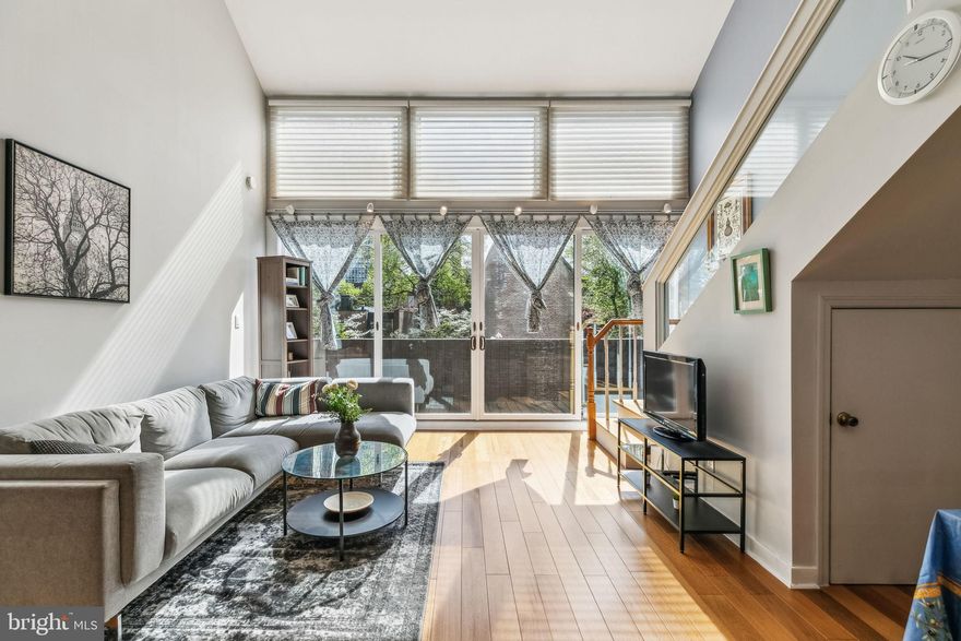 Welcome to 267 S 4th St, Unit B — an impressive and beautifully renovated bi-level 2-bedroom, 2-bathroom townhome-style condo located in the heart of Philadelphia’s highly sought-after Society Hill neighborhood. Spanning 1,287 sq. ft. of modern living space, this home perfectly blends sophisticated design, comfort, and convenience. As an added bonus, this residence includes DEEDED PARKING in a secure, private off-street lot — a rare and valuable amenity in this historic part of the city. Step inside to discover warm-toned hardwood floors, central air, and abundant natural light throughout. A flight of stairs leads you to the main level, where you’ll find a stunning chef’s kitchen featuring white quartz countertops and backsplash contrasting against rich dark wood cabinetry, stainless steel appliances, and a breakfast bar perfect for casual dining or entertaining. The kitchen flows seamlessly into the open-concept living area, anchored by floor-to-ceiling windows and an eye-catching cathedral ceiling, creating a bright and airy space ideal for gatherings. Just off the living room, newly installed balcony doors open to a private TimberTech Trex Select balcony — the perfect retreat for morning coffee or evening relaxation. Also on this level is a generously sized bedroom and a full renovated bathroom, complete with light gray tile flooring, custom subway-tile shower, and a modern vanity. A stylish staircase with a glass center railing leads to the upper level, where you’ll find a large primary bedroom suite featuring high ceilings, abundant closet space, and a private dressing area. The en-suite bathroom offers a sleek gray tile backsplash, light gray floors, and a convenient in-unit laundry area with a newer washer and dryer. Need more space? Above the primary suite, a bonus loft area awaits — perfect for a home office, gym, playroom, or guest accommodations. Just below, a charming custom-built nook with a bed and storage cubbies offers even more flexibility for your lifestyle. Enjoy all the charm of Society Hill — tree-lined streets, historical landmarks, and top-tier dining including Zahav, Positano Coast, and Fork. You’re just steps from scenic parks, grocery stores, fitness centers, museums, and the vibrant Philadelphia waterfront. Commuting is a breeze with easy access to SEPTA bus routes, PATCO, and the Market-Frankford Line. Don’t miss this unique opportunity to own a spacious, turnkey home with private parking in one of Philadelphia’s most beloved neighborhoods. Schedule your private showing today!