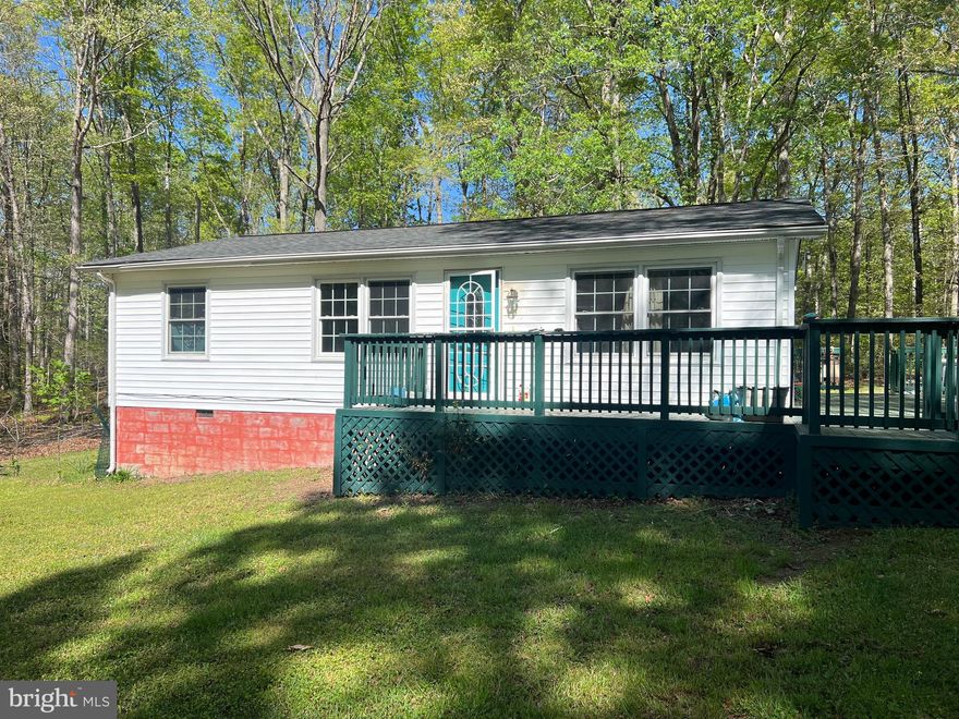 Welcome Home! Discover serenity in this charming one-level ranch-style home, nestled on a private 1-acre lot enveloped by trees. With numerous trees removed, the flat lot offers ample parking and a private, long driveway leading to a peaceful oasis. Step inside to find 3 bedrooms, 1 full bath, and complete seclusion set back from the road. Outside, a spacious deck invites you to unwind. Recent upgrades include a new roof in 2021, hot water heater in 2022, and HVAC system in 2018. The kitchen boasts a propane gas stove, and two sheds provide additional storage. Don't let this opportunity pass you by. Schedule your viewing today. Enjoy the convenience of being just a 10-minute drive from the upcoming Kalahari Resort/water park and I-95. Assumable VA Loan is active with sub 3% rate.