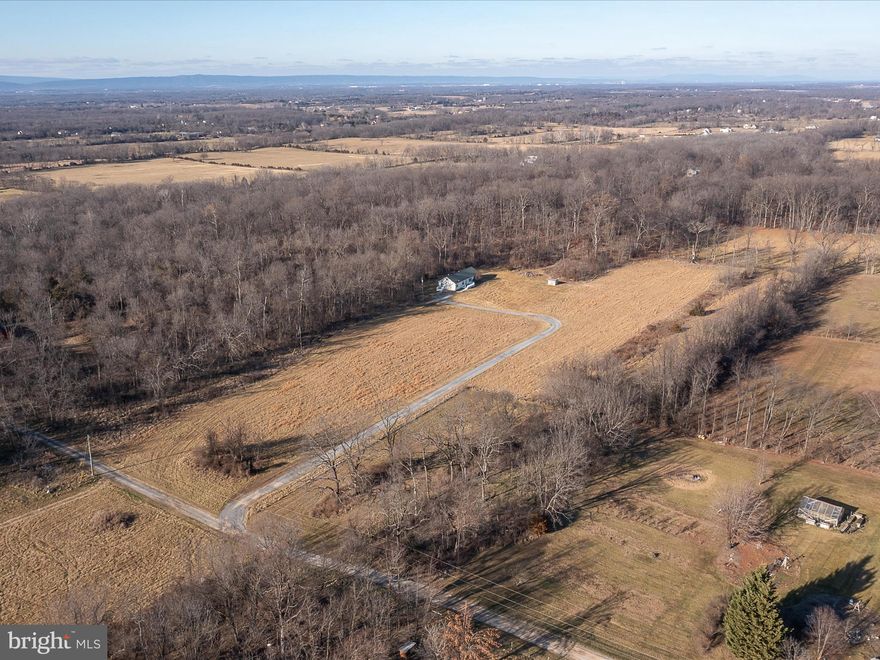 10.99 ACRES, less than 10 minutes from downtown Charles Town. This 3-bedroom, 2-bathroom rancher is complete with over 1900 square feet on the main level. The 10x72 attic includes a connecting stairway and is ready to be finished to add living space. Updates include fresh paint from top to bottom, new stainless-steel appliances, new granite counter tops, new HVAC, new LVP flooring throughout, and new hardware and fixtures. Other features include a fireplace as well as a brand-new front, side, and rear deck, with maintenance free trex decking boards and white vinyl handrails. Don't miss out on this rare property. Schedule a showing TODAY!