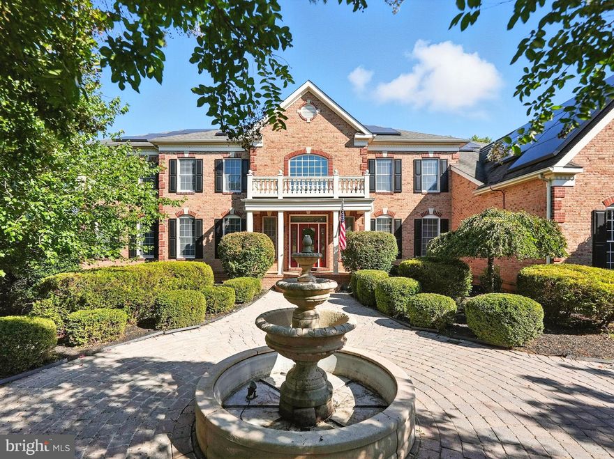 BEST OF SHENSTONE! Nestled in the prestigious Shenstone Farm community of Leesburg with beautiful rolling hill views, this extraordinary all-brick estate offers over 9,000 square feet of refined living space on a private 3+ acre lot, framed by $100,000+ in lush landscaping, mature trees, and hardscaping. A true Georgian-inspired masterpiece, this residence blends timeless elegance with modern luxury in a setting that feels like a storybook come to life. From the moment you step into the two-story foyer with its dramatic curved staircases, the home impresses with scale and sophistication. The grand design flows seamlessly into a spectacular two-story family room with coffered ceilings, flooding the living spaces with light and elegance. The main level showcases a stately library with built-in bookcases, an elegant side conservatory with a dual-sided fireplace shared with the formal living room, and a formal dining room perfect for entertaining. A sun-drenched Palm Beach sunroom with skylights offers serene backyard views, completing the suite of luxurious gathering spaces. The gourmet Palladian kitchen is a chef’s dream with commercial-grade appliances, solid cherry cabinetry, dual dishwashers, oversized island with beverage fridge, and a spacious walk-in pantry. Two half baths, a laundry room, and mudroom lead to the three-car garage for everyday convenience.

The owner’s suite is a true sanctuary with dual closets, a private sitting room, and a spa-inspired bath featuring dual vanities, soaking tub, and walk-in shower. Upstairs, expansive teen suites with private baths and play/study rooms provide ample space, along with an additional ensuite bedroom and upper-level laundry. The finished walk-out lower level offers a full lifestyle experience with a wet bar, expansive rec area with fireplace, game and exercise rooms, bonus rooms, and two full baths.

Outdoors, enjoy the storybook setting with a large deck, paver patio, charming gazebo, fenced rear yard, and mature trees for ultimate privacy. Recent updates include an $80,000 Tesla solar panel system delivering efficiency and sustainability. With three fireplaces, refined finishes, and a seamless blend of comfort and grandeur, all just minutes from downtown Leesburg, the Greenway, Tysons, Dulles Airport, and Loudoun County’s finest wineries, this estate is truly Shenstone Farm’s Finest.