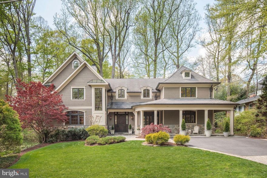 Set on the most scenic, wooded street in coveted Bannockburn Estates, this 6 or 7-bedroom custom-built home is a seamless blend of timeless architecture, elevated design, and serene natural beauty. Privately situated on a professionally landscaped half-acre, it offers exceptional seclusion—just minutes from downtown D.C., Northern Virginia, and the highly ranked Whitman school cluster.
From the moment you enter, the grand two-story foyer, sweeping custom curved staircase, and soaring floor-to-ceiling window create an unforgettable first impression—framing views through the formal dining room and out to the lush, wooded backyard.
Standout features include rich walnut floors, gas and wood-burning fireplaces with custom-designed facades, and crafted millwork and cabinetry—each element reflecting the home’s exceptional attention to detail and quality.
The expansive main level is designed for effortless living and entertaining. Multiple formal and informal living spaces are anchored by a dramatic dining room, flanked by two spacious family rooms—offering flow and flexibility for grand gatherings or quiet evenings at home. French doors open to a sweeping curved deck and a beautifully constructed screened-in porch, ideal for outdoor dining or peaceful relaxation amid nature.
The spacious chef’s kitchen is both elegant and functional, featuring high-end appliances, a generous island, walk-in pantry, powder room, and a large mudroom with its own private entrance. A main-level suite includes a full bath with a steam shower and an additional powder room—perfect for hosting guests or accommodating multigenerational living with ease.
Upstairs, the private primary suite is a serene retreat with tranquil treetop views, a spa-like marble ensuite bathroom with an air bath and oversized shower, and dual dressing rooms that offer versatile use as an office or nursery. Additional bedrooms on this level each include walk-in closets and ensuite baths—offering unmatched comfort, space, and flexibility. A central laundry room enhances everyday convenience.
The lower level expands the living space further with a large recreation room, hobby or craft area, ample storage, and a bonus bedroom with a full private bath—ideal for an au pair or extended-stay guests.
Outdoors, the grounds are beautifully landscaped and enhanced with irrigation and soft landscape lighting. Two oversized one-car garages are tucked discreetly beneath the home and accessed via a private drive—preserving the elegant front elevation while offering privacy and convenience.
Additional features include copper gutters, a whole-house generator, and a three-zone HVAC system (with two zones recently replaced).
This extraordinary home combines timeless elegance with modern comforts—a rare and refined offering in one of Bethesda’s most sought-after neighborhoods.