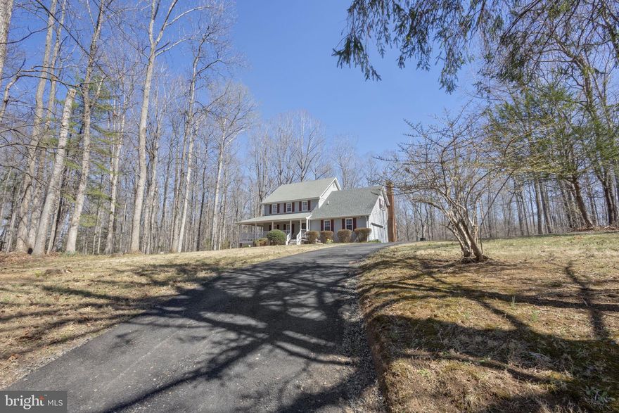 Tucked away on nearly three acres, this charming 4-bedroom, 2.5-bath colonial offers the kind of peace and privacy that's hard to find. Set on 2.88 acres — the largest lot in the neighborhood — this 1986-built home is beautifully framed by mature woods and a generous open front yard, delivering a true sense of seclusion while remaining conveniently located in Culpeper County, just minutes from Warrenton and Culpeper.
Step onto the inviting wraparound covered porch and you'll immediately feel at home. Inside, rich hardwood floors flow throughout the main level and into the primary bedroom, creating a warm and cohesive living space. The living room is anchored by a striking whitewashed brick fireplace with a natural wood mantel, flanked by charming octagonal windows that fill the room with natural light. Large sliding glass doors open to a rear deck overlooking the wooded backyard — a perfect spot for morning coffee or evening relaxation.
The kitchen is a true workhorse, featuring maple cabinetry, durable Corian countertops, stainless steel appliances, and a center island that adds both workspace and casual seating. A breakfast area sits just off the kitchen, and a formal dining room is nearby for entertaining.
Upstairs you'll find generously sized bedrooms with ample closet space. The unfinished walkout basement presents an exciting blank canvas — with concrete floors, high ceilings, and exterior access, it's ready for a future rec room, home gym, workshop, or additional living space.
Outside, the two-car attached garage provides convenient storage and access, while the expansive 2.88-acre wooded lot offers unmatched privacy and room to roam. Whether you're watching the seasons change from the porch or enjoying the quiet of your own private retreat, this 1,988-square-foot home captures the best of Virginia country living.
Nearby schools include Emerald Hill Elementary, Culpeper Middle, and Culpeper County High School. Easy access to Route 229 and Route 211 makes commuting a breeze.