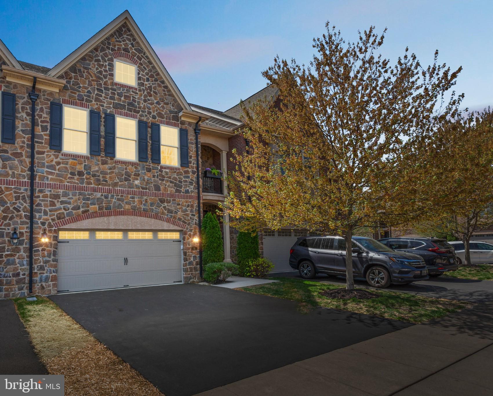 Welcome to Walden Square, A Rarely offered, Simply Stunning town home in a community that has that old world elegance in build and design. 52 David Drive is situated on one of the premier interior lots in the community, a short walk to quaint downtown Newtown borough with restaurants, shops, farmers market and more, located in a superior zip code of Bucks County, and built with all offered top of the line upgrades, rounded corner walls, with the exception of the finished basement. Top of the line surround sound speakers throughout the home that allows you to enjoy different music from each room or enjoy your favorite movie with theater quality surround sound. This home featuring custom closets, window dressings and lighting fixtures throughout. Pull up and behold, perfection in this townhome. Elegantly appointed with substantial hardwood flooring on the first floor, a gourmet /chef style kitchen with top of the line MONOGRAM appliances, even a convection oven, Carrara marble counters and Island. A huge open first floor plan ..encompassing kitchen living and dining, the dining room offers Coffered ceilings, Wainscoting from the foyers to the dining area, living room you'll find a gas stone fireplace tucked in the corner and a relaxing backyard deck. Upstairs you'll find a large Primary suite that has a 5 star hotel quality like design, great natural light with sitting area, several Grand chandeliers, two nicely appointed walk in closets on the way to your Carrara marble covered primary suite bathroom with soaking tub and separate walk-in shower, on the other side of this suite you will find a Luxurious dressing room with a wonderful grand chandelier, custom shelving throughout ,plenty of storage, a sitting area and its own private Juliet balcony to enjoy your morning coffee and listen to nature. Making your way down the hall you'll find a large walk in laundry room, 2 bedroom's ,one with is own ensuite full bath nicely appointed with Carrara marble ,then a hall full bath with the same Carrara marble. Making your way down to the unfinished lower level full unfinished basement just waiting for you to put your final touches on this perfect townhome and make it your own. Let's not forget the large 2 car garage with brand new epoxy flooring. Poised in the back area of the development, truly serene. Come home to 52 David Dr., simply unpack and begin to enjoy your luxury care free living . If there is inclement weather please wear booties at the front door over shoes, or remove shoes