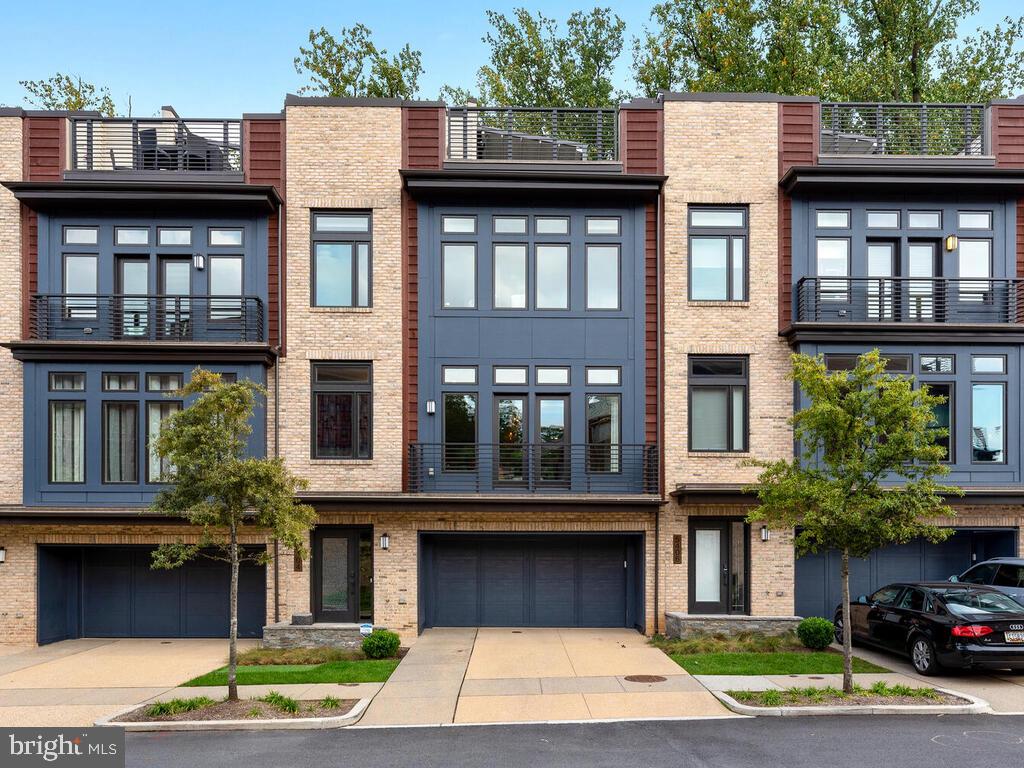 Discover unparalleled luxury at Grosvenor Heights. Built by renowned builder EYA, this
Harrison Model townhome offers a perfect blend of elegance, technology, and
sophisticated living.Â
The main floor boasts impressive 10-foot ceilings, with a kitchen that features paneled
appliances seamlessly integrated into the cabinetry. Enjoy the custom-designed
backsplash, a spacious island, and bespoke pendant lighting that adds to the kitchens
charm. Start your day at your own coffee bar perfect for your morning lattes, and take
advantage of an abundance of cabinet storage, including convenient pull-out pantry
cabinets. Unique grass-cloth wallpaper adds an artistic flair to the space, while hidden
built-in bookcases surrounding the fireplace offers a perfect blend of style and
functionality. In-ceiling Bowers and Wilkins speakers add an immersive audio
experience on the main level as well as throughout the home.
Enjoy ultimate privacy as your home backs to lush trees, offering a peaceful retreat
while still being situated in a premier location. Every detail is curated for luxury, from the
private elevator to the expansive rooftop terrace with a retractable awning, outdoor
speakers, a mounted TV, and a fully equipped outdoor kitchen perfect for entertaining.
The modern staircase with sleek metal railings enhances the contemporary design.Â
The Bedroom level showcases an Owner's suite complete with automated Lutron room-
darkening shades, ceiling speakers, a spacious custom closet, and a spa-like
bathroom.Â
The entry level includes a versatile flex space ideal for a home office, bedroom, or gym,
with access to the fenced backyard featuring low-maintenance field turf ensuring the
grass is green year-round!
This unit features a state of the art, fully integrated home automation Savant system
that seamlessly controls audio and video throughout every TV and speaker in the
home.Â
The Grosvenor Heights community is in a premier location with convenient
access to shopping, dining, metro and more.