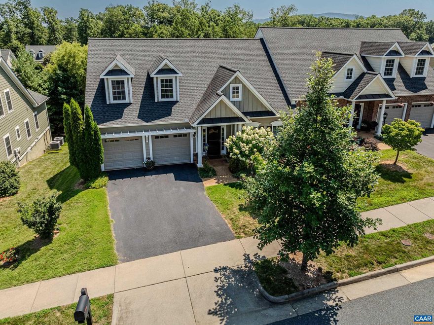 Elegant home with an abundance of charm and main level living spaces in the heart of Charlottesville. Spacious open floor plan features hardwood floors and white shutters, and light filled rooms throughout the main level.  Entertain in the vaulted great room with build-in speakers, custom shelves and a gas fireplace. The gourmet kitchen features white cabinets with two lazy susans, granite counters, upgraded stainless appliances and tile backsplash. Entertain outdoors on the screened in porch overlooking the lovely back yard. Main level living continues in the elegant primary suite with walk-in closet and private bathroom with double sink vanity and tiled shower. Work from home in the main level office/bedroom too!  Main level laundry room features a large sink and upgraded storage. Finished walk-out basement features a large rec room with ceiling fan, guest bedroom with oversized closet, full bathroom, office/exercise room and storage room. Large concrete covered patio for outdoor dining or grilling too. Zero step entry, wide doorways and two car garage make this home a must-see!,Granite Counter,White Cabinets,Wood Cabinets,Fireplace in Great Room