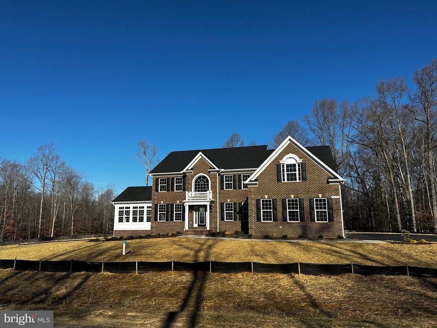 Beautiful QBHI Brick front Willow with 3 car garage, side sunroom, upgraded hardwood flooring, stainless steel appliances, large corner lot.  Call to build your QBHI home today