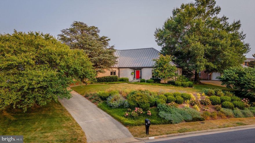Light pours into this one-of-a-kind, one-owner city home, where soaring ceilings, exposed brick, and custom touches create a warm yet dramatic living space. Anchored by a wide central foyer, the main level flows into a stunning two-story dining area with picture windows and skylights, and a sunken living room with parquet floors. The spacious kitchen and great room feature a large center island with second sink, Corian counters, gas range, hardwood floors, and a wood-burning fireplace framed by an expansive brick hearth. A vaulted sunroom, home office, powder room, full bath, and oversized laundry room with built-ins round out the main level. Upstairs you’ll find a loft area, two bedrooms, full bath, and a primary suite with gas fireplace, jetted tub, skylight, and large walk-in closet. Enjoy rec space and storage in the basement. Brick exterior, metal roof, pavered patio, brick outbuilding, mature landscaping, and mountain views complete the package!