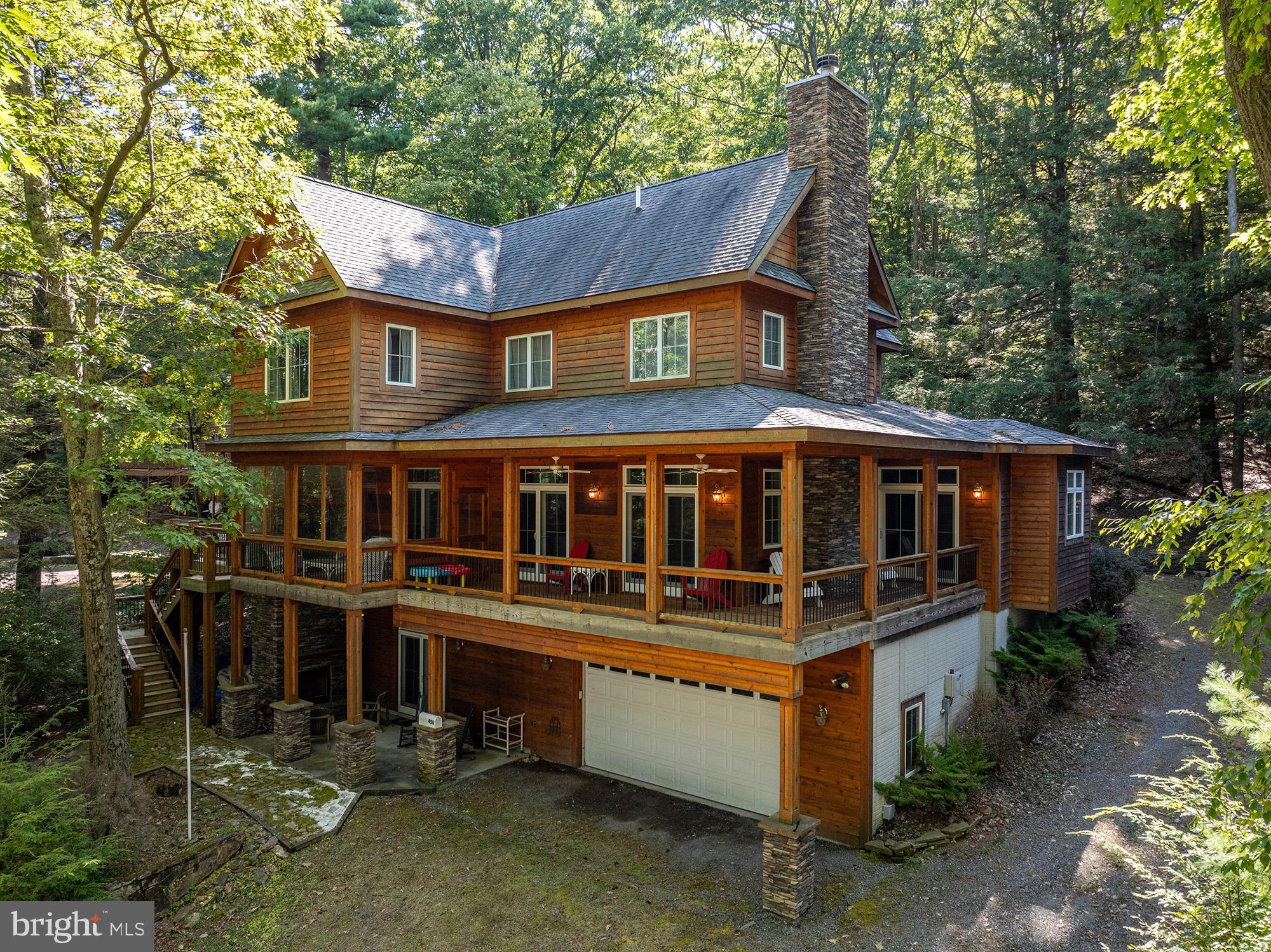 Luxury meets comfort in this stunning 5-bedroom, 4.5-bathroom split lakefront property central to all Deep Creek Lake has to offer. Custom-built for the current owners in 2014, it boasts breathtaking lake views, impeccable high-end details, and thoughtful design throughout.
Step inside to find an open-concept living space with high ceilings, rich hardwood floors, and a stone fireplace that creates a warm and inviting atmosphere. The gourmet kitchen is a chef’s delight, featuring top-of-the-line appliances, custom cabinetry, and a spacious island ideal for entertaining. There’s plenty of room for a large dining table as well, and a powder room on the main level provides everything you need for gatherings of friends and family.
The primary bedroom on the main level is an oasis of comfort, with a massive walk-in closet, en suite bathroom, and doors to the deck for your morning coffee overlooking the lake. Four bedrooms and 2 bathrooms comprise the second floor with many special touches like window seats and built-in dressers.
The basement features heated floors throughout, a spacious rec room with wet bar, a full bath and access to the patio. The two-car attached garage is large enough to store your boat along with ample storage.
Outside, you’ll discover an expansive patio with an outdoor fireplace. A huge wrap around deck provides plenty of space for grilling and gatherings with fabulous views of the lake. A fully-enclosable sunroom with another fireplace allows for enjoyment of the natural beauty of the lake in any weather. Just steps away, your 100 feet of level shoreline boasts a Type A deep water dock and a shed for your lake toys. The State Park and Meadow Mountain are on the opposite shoreline, ensuring uninterrupted views for years to come.
This home is a rare find, offering the ultimate Deep Creek Lake lifestyle. Don’t miss the opportunity to make this exceptional property your own!