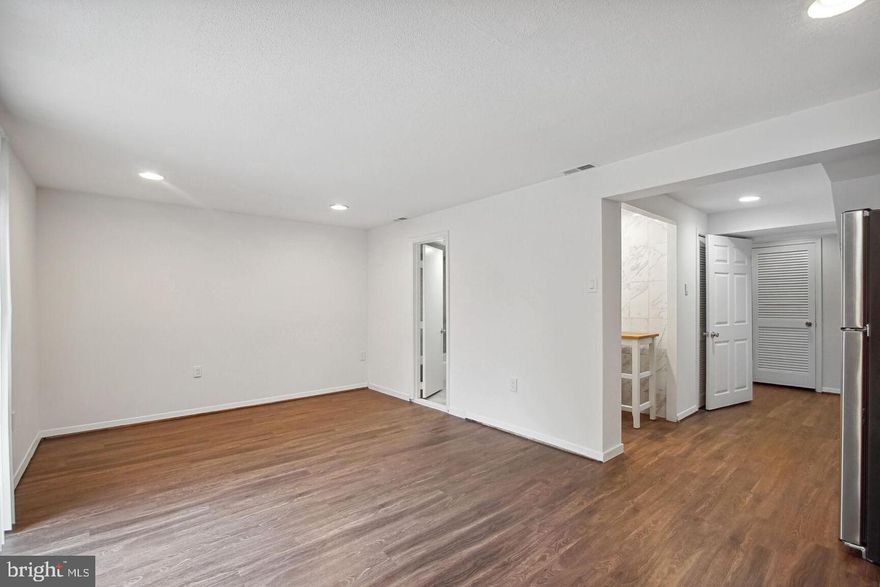 Charming Basement Apartment with Private Entrance – 1 Bed | 1 Bath | Kitchenette | Hyattsville, MD

Welcome to this beautifully updated basement apartment in a quiet townhome. This private rental features its own separate entrance through the backyard, offering both privacy and convenience.
The unit includes one bedroom with tile flooring, a full bathroom with tub, a spacious living area with wood-style flooring, and a sleek kitchenette complete with butcher block counter space, a deep sink, and a full-size refrigerator. Recessed lighting and fresh white walls give the home a bright, modern feel. Additional features include a large closet for storage and access to the washer and dryer located on the upper level of the home. Enjoy your own outdoor entry and direct access to the backyard. Perfect for a single tenant or professional seeking an affordable, stylish living space with great access to local shops, and public transportation.