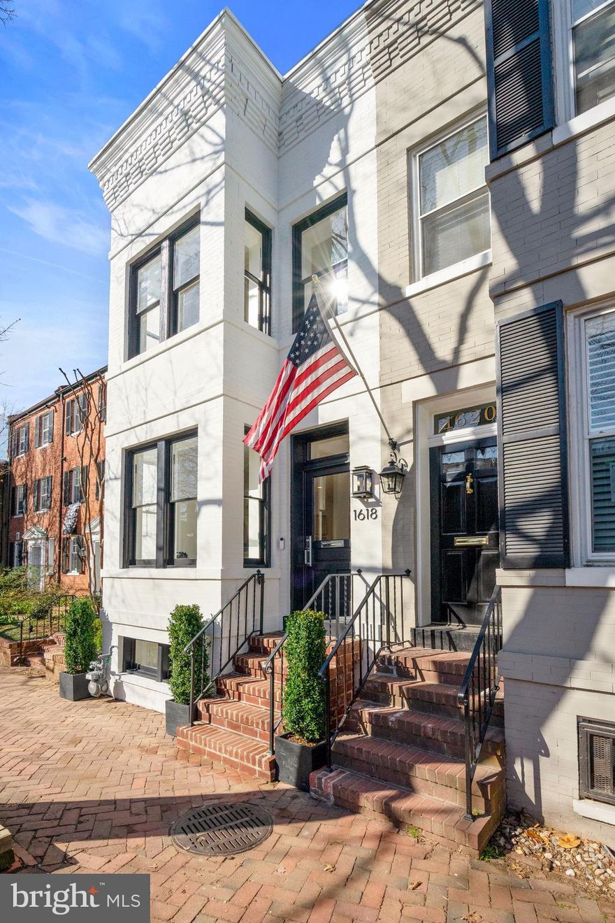 NEW PRICE! Georgetown charm in perfect harmony with modern luxury, creates a stunning urban oasis at this meticulously fully renovated West Village gem. This home offers you quintessential Georgetown living, with approximately 2,100 square-feet of carefully curated space, 3 bedrooms, 3.5 bathrooms and a professionally landscaped patio garden that takes your breath away.  Every inch of the home has been carefully planned for optimal use and features top of the line Thermador appliances, luxury lighting, Rohl fixtures, and features marble throughout the home. The open floor plan is perfect for family gatherings and entertaining guests. In the kitchen, enjoy only the best appliances, pendent lighting, and quartz counter tops. A second family room is located just off the kitchen with a warm fire place, built-in shelving, and storage.  Huge 8 foot French doors open up to the stunning patio garden creating an indoor outdoor entertainers paradise. The outside oasis comes with lighting and outdoor speakers. The upstairs offers a primary suite of your dreams, with a walk-in closet, en-suite bathroom, and glorious built-in shelving for extra storage. Two guest bedrooms, another bathroom and washer and dryer are also on the second level. The lower level offers a wonderful place for entertaining. It includes a wet bar, and  a full size bathroom with a shower. This house is smart! Audio speakers are placed throughout the interior, and on the back patio. Control the lights, audio, temperature, and appliances all on your smart phone.