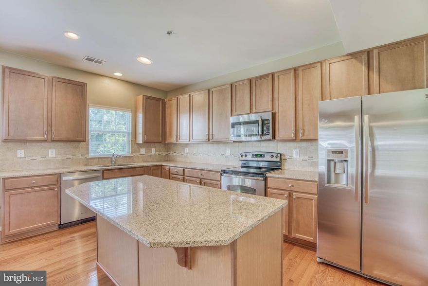 Large ,upgraded, Town home in very desirable Monmouth Meadows.  Enjoy 3 bedrooms above grade with 2 full baths,  office or possible 4th bedroom on lower level along with a 1/2 bath on both the main and  lower levels.   Gorgeous kitchen with Silestone counters, large island, hardwood floors, and stainless appliances.  Kitchen/dining area opens to rear paver patio and  grassy community yard area backed by trees.  Master suite with walk in closet,  separate shower, tub, and double vanity.   Built in 2012 and impeccably maintained.  Enjoy all of the above along with the great community amenities.