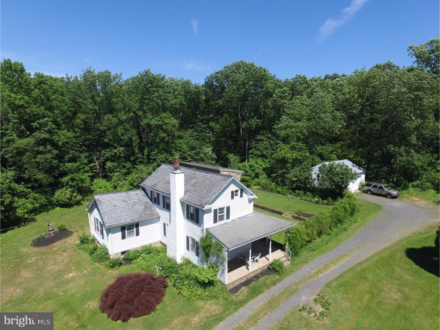 The essential "country house" to get away from it all in Bucks County. Alluring in its timeless simplicity, the home has well-sized rooms, 2/3 bedrooms, with one main-level bedroom and bath. The 17-acre parcel includes a 2-car garage and a converted stone chicken coop, known as "the Folly." Set back off a truly quiet road, a verdant expanse of lawn spreads out in front of the wisteria-covered porch. While it has tons of potential, it is a charm-filled jewel just as it is. Random-width floors, pie stairs and 2 fireplaces pack this home with character you can't duplicate. The second floor can be 2 bedrooms or one large suite. The European sensibility has been cultivated for years. The perennial gardens and woods achieve year-round estate-quality privacy. Blissfully close to the shops, cafes and restaurants of Frenchtown, the location is easily accessible to the NYC bus. Far removed from the rush of the modern world, the Folly is an all-stone, 25-foot-long building with heat and plumbing, perfect for an art studio, large home office or private yoga studio. Once inside, relaxing under the four skylights, there is nowhere else you need to go. Sweet.