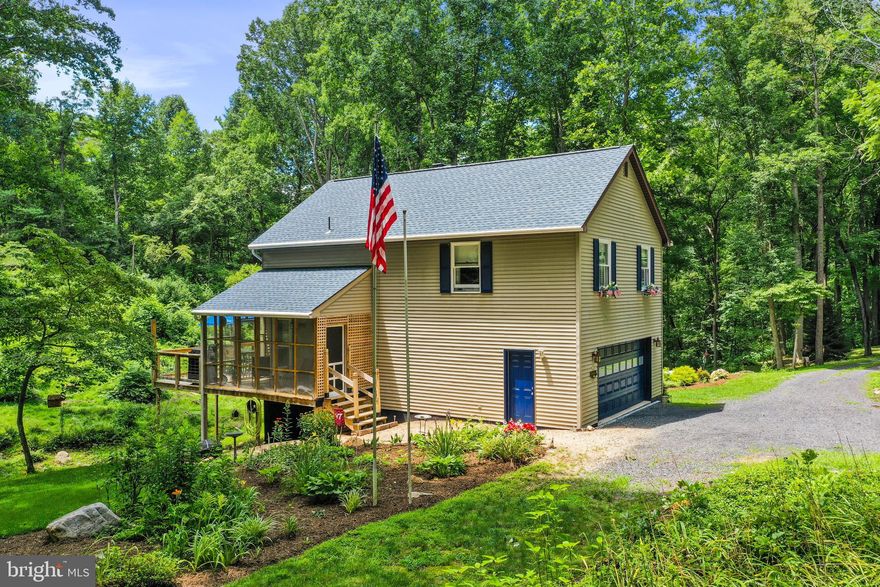 Country Living and Relaxation at its finest!  This property in Edinburg, Virginia is located off of Palmyra Church Road on 5 beautifully manicured acres.  Outside there is a great deck and screened-in porch for enjoying the seclusion, flower beds, or the seasonal wet stream that runs the entire length of the property.  The home has an open floor plan with eat-in kitchen and living room with gas log fireplace, 2 bedrooms, and a very large bathroom.  There is no shortage of storage with two walk-in closets, a 2 car garage, and an unfinished basement with wood burning fireplace. The home also offers chair lifts on both interior stairways, but can be removed if desired.  Don't wait on this one - it is well-maintained, and it will not last long!