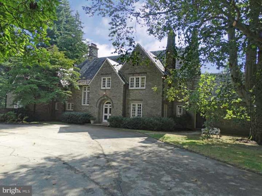 Spectacular 1926 stone Norman style 7 bedroom, 4.2 bath house on secluded lot set back from the street.  A most desirable location. Architecturally rich and full of character inside and out. Gracious interior with terrific light from rear southern exposure.  Double door to foyer with flagstone floor. Entry hall with large window over wide stair, coat closet, powder room. Living room with marble fireplace, bay window, built-ins, glass doors to terrace.  Dining room with marble fireplace, built-in display shelving.  Family room with fireplace. Large, inviting eat-in kitchen with Wolf gas range, fireplace, center island, big eating area, storage closets, back stair to 2nd floor : this is the comfortable  space everyone will want to gather in for both  everyday and entertaining. Butler's pantry with built-ins and laundry. Sunporch (off kitchen and dining room )with 3 sets of french doors. Big, bright second floor hall. Master bedroom suite with fireplace, sitting/dressing room (8x13), tile bath.  Front 2nd bedroom with fireplace, bath. Middle 3rd Bedroom. 4th bedroom (a suite) with fireplace, small hall with walk-in closet, sunporch, bath. From second floor hall there is a door to a work/playroom with built-ins, back stair to kitchen, hall to 5th and 6th bedrooms (9x10, 9x9)and hall bath. Third floor has large central hall/room (8x32)with large cedar closet, large storage closet, glass door to small balcony, 7th bedroom (13x14) with sink and large walk-in closet, large attic storage room. Pleasant basement (4 rooms) with PR and OE. Hardwood and pine flooring.  Seriously great storage and closets. Newer gas heater and hot water heater. Front courtyard parking for many cars; terraced rear lawn/gardens  with wide steps from stone terrace to beautiful pool. Fabulous open porch off Family Room has columned/arched walls. Lovely, small stone garden house with cold frame and cutting garden.  3 car detached garage with storage.  There is a CHHS Conservation Easement with the property regarding the facade and land; premises A & B. Shared driveway with 452 W. Chestnut Hill Avenue: easement/right of way. Gas meter to 452 in 460 basement and gas line through 460 property to 452. This is a captivating property with a coveted location.