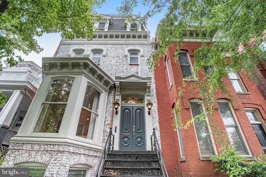 Yes, it's THAT house!! Spectacular 21' wide Capitol Hill Grande Dame w/exquisite entertaining spaces inside and out. This stunningly-renovated rare Second Empire style home seamlessly melds all modern amenities w/historic details including impossibly tall ceilings w/gorgeous original plaster medallions throughout, beautiful wood floors, 4 wood-burning fireplaces and aprox 3230sf of living space in the 4 bedrooms + 2 offices + huge family room, 3.5 bathrooms of the main home, PLUS a separate 150sf mini-gym out back, totaling aprox 3380sf per pro floorplans
A commanding presence a half block from Stanton Park, featuring ornate historic iron stairs, a gracious double door entry foyer and large stair hall w/original banister and curved railing. The spacious and grand living room w/almost floor to ceiling bay windows and a fireplace w/original slate mantel welcomes conversation. Open the tall original pocket doors and step into a banquet-size dining room w/matching fireplace, and a stunning kitchen opening to huge patio beyond, creating the perfect flow for both large-scale or more intimate entertaining, w/a convenient powder room at rear of stairs.
Architectural Digest-worthy immense and bright kitchen boasts stainless steel Viking appliances, built-in pantry, a long wall of tall cabinets above tiled backsplash and Carrara marble countertops and a huge center island breakfast bar w/farm sink and microwave. Side wall of windows and rear glass wall flood the space w/light. Imagine your next al fresco fete, stepping out to the very wide, DEEP slate patio featuring a deluxe built-in outdoor cooking area w/gas grill, built-in dining bench, 3 fans, lighting, and an evergreen turf area sheltered by mature tree. A mini-gym/yoga space currently occupies the flexi-use 150sf separate building at the rear of the property, while a cleverly-concealed gate to the alley makes for super easy bike and stroller access.
The generous and comfortable primary ensuite bedroom fills the second floor: a spacious front bedroom w/large windows, a huge custom walk-in closet, lovely subway-tiled bath w/tub, a very large office/sitting room w/fireplace and a door to the massive private terrace, an oasis in the sky to relax on chaise lounges w/cocktails or to enjoy an outdoor yoga class w/friends.
The skylit 3rd floor features 2 generously-sized bedrooms, the front w/a huge walk-in closet, the back w/a Capitol dome view, and the beautiful hall bath has marble tiles and glass stall shower. 
Connecting lower level features tall ceilings, w/generous entry foyer including space to sit and put on boots. A bright spacious family room w/windowed bay and wood-burning fireplace offers multiple places to relax and enjoy movie nights. At rear is the 4th bedroom, with separate 2nd office area accessed from inside or out, the 3rd bathroom w/heated floor plus glass stall shower, and a front-loading washer/dryer closet across from clever storage cubby plus microwave underneath stairs. 
Rest easy knowing this gorgeous historic home was lovingly restored and almost completely redone in the past 5 years (featured in Home and Design Magazine 2019) w/a new roof, central AC, kitchen, bathrooms, floors, most windows, front and rear exterior spaces, plus mini-gym/yoga building. Enjoy the best of Capitol Hill’s past and present in an enviable location a half block to Stanton Park and Peabody/Cluster School, and a short stroll to Eastern Market, US Capitol Complex, Whole Foods, H Street, Union Station, Barracks Row, multiple Metros and BikeShares. Carpe Diem!