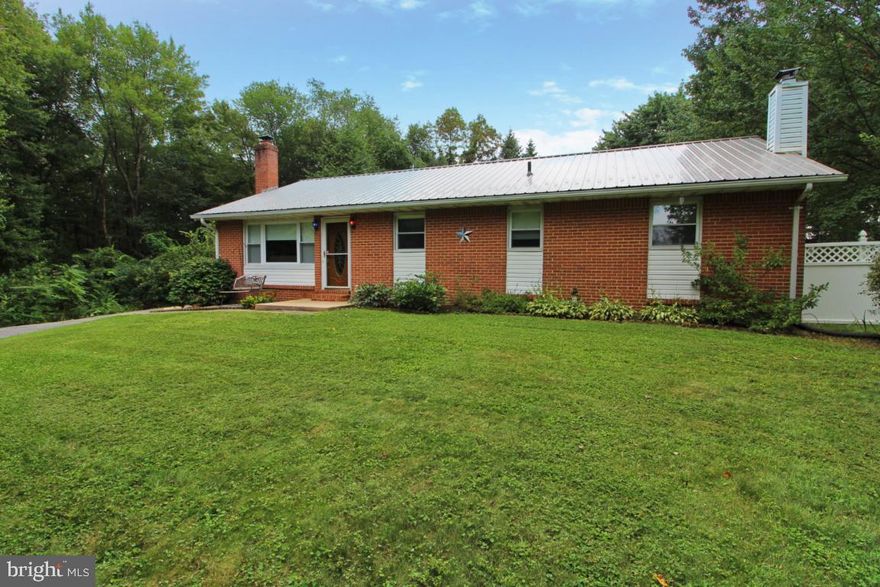 Brick rancher in quiet neighborhood at end of the street.  This home has been lovingly cared for and is priced to reflect some updating that it needs. Beautiful hardwood floors welcome you into the living room with a brick surround and pellet stove. The kitchen has ample counter space and cabinet space as well as a deck right off of it perfect for entertaining. Large master bedroom with an attached full bath, 2 other nice sized bedrooms and hallway full bath as well as a 4th room that can be an office or additional bedroom area complete the main level.  The basement has a storage area, finished living area with a wood stove, an additional room that can be used as a bedroom and a full bath. Wait until you see the storage possibilities in the detached, heated garage with electricity. The main area  is 26' x 32' including an upstairs with a separate entrance. The garage addition on the back is 16' x 24' and has it's own entrance plus carport, ideal for a workshop/hobby space.  With convenience to commuter routes and yet a peaceful setting, this home is ideal, schedule a showing today!