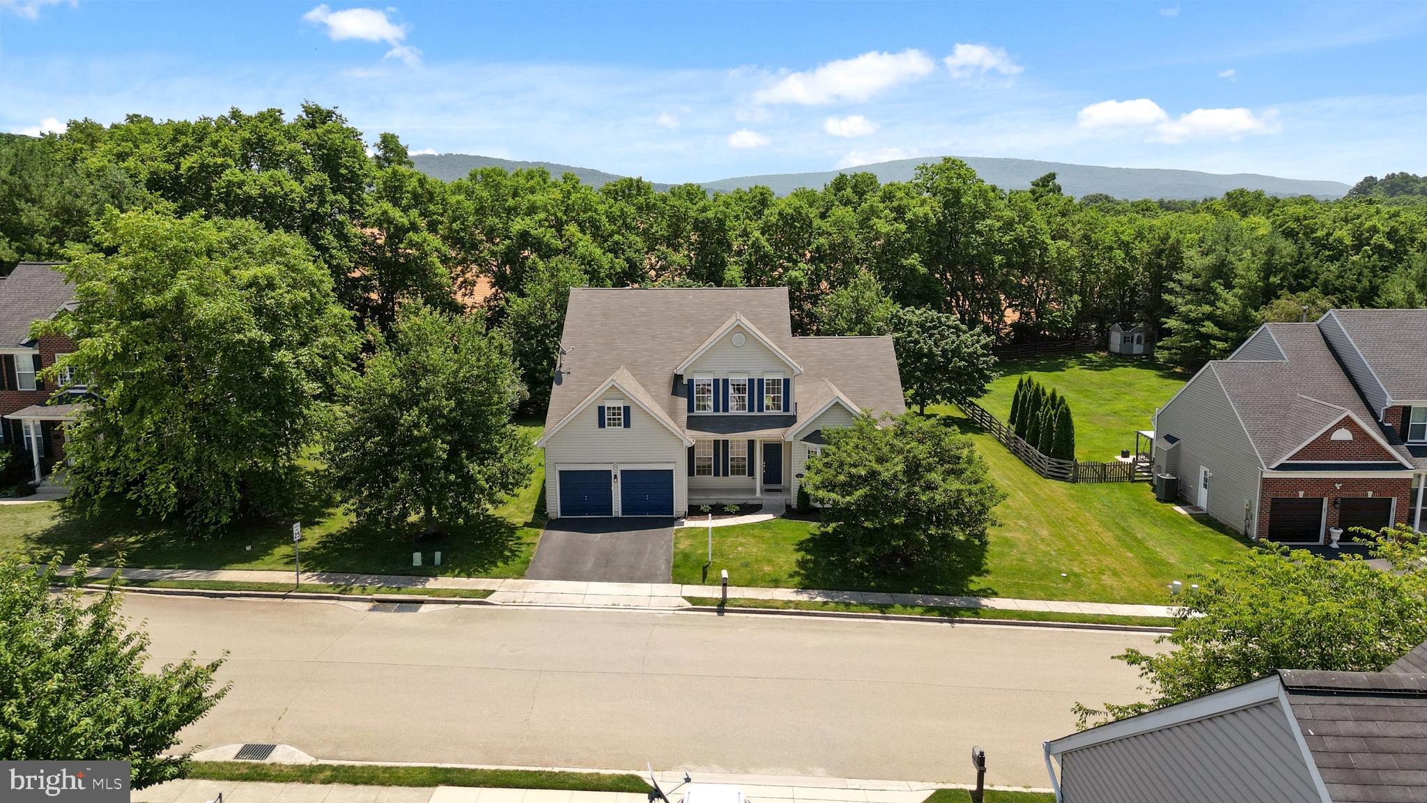Located in the desirable Crestwood Community of Boonsboro, Maryland, this Colonial-style home features an inviting open floor plan featuring three bedrooms, two full bathrooms, and one half bathroom. The grand two-story family room boasts a gas-burning fireplace and an abundance of natural sunlight. The family room seamlessly opens to the kitchen area.
The spacious kitchen features a corner sink with large windows that provide views of the lush backyard. Sliding glass doors open to a full-length rear patio and a flat yard that backs up to trees and farmland. The main level features a laundry room with a washer and dryer, which leads to a two-car attached garage. Additionally, the main level features a master suite with a spacious master bathroom, complete with a soaking tub, a shower stall, and a double vanity.
For entertaining, the formal dining room is adorned with decorative white columns and hardwood flooring. There is also a front office or den that has the potential to be converted into a fourth bedroom.
The upper level features an open living room area, two additional bedrooms, and a large full bathroom with a double vanity. The lower level is fully unfinished, with walk-up stairs providing access to the backyard. Additionally, the property includes leased solar panels.
