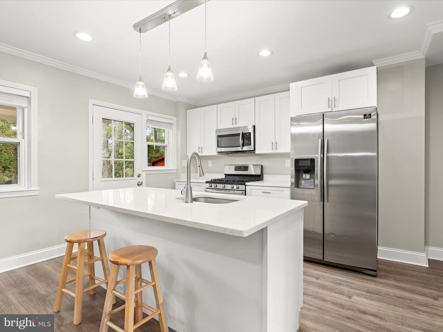 Step inside this wonderfully renovated 3-bedroom, 2-bath rowhome that combines spaciousness with a sense of privacy. The inviting, awning-covered front porch leads you into an open main level where the sunny living room features updated wood-inspired plank flooring, a soothing neutral palette, crown molding, and recessed lighting that flows seamlessly into the dining area and kitchen.
Your culinary skills will shine in the beautiful kitchen, complete with stainless steel appliances, gleaming quartz countertops, and a center island accented by modern pendant lighting. The adjacent dining area is ideal for both casual meals and festive gatherings. Step outside to the covered deck overlooking the grassy rear lawn—perfect for relaxing or entertaining.
Upstairs, you’ll find the primary bedroom along with two additional bedrooms featuring plush carpeting and a hall bath refreshed with contemporary updates. The expansive finished lower level with walk-out steps adds even more living space, offering a recreation room, laundry area, full bath, and a flexible area that easily serves as a fourth bedroom.
Centrally located near I-83, Route 1, and I-695, and close to local schools, this home offers comfort, functionality, and easy access to everything you need.