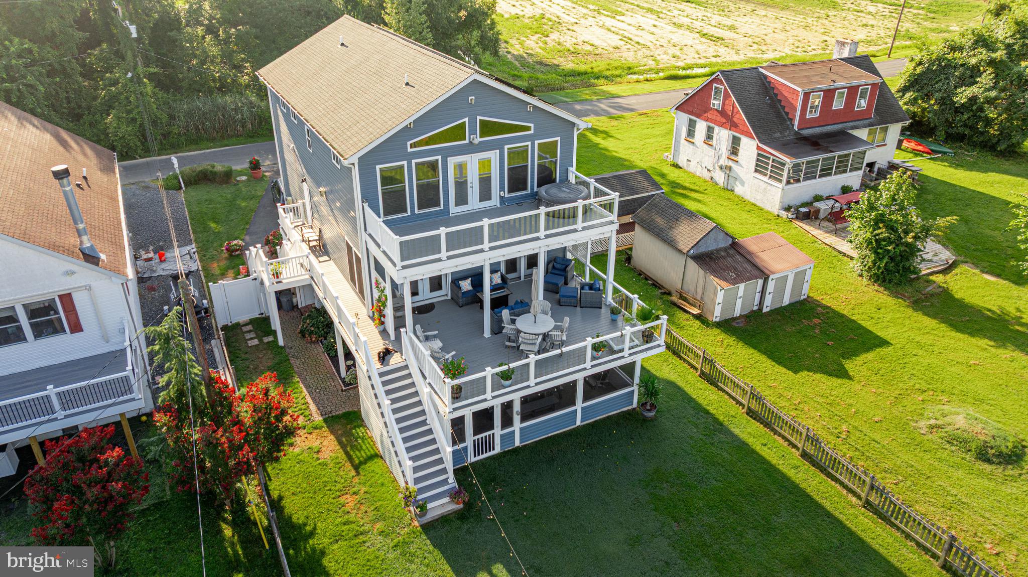 Stunning direct waterfront property on Galloway Creek! No expense was spared with making this property absolutely perfect! Breathtaking views of the Galloway and front row seating for daily sunsets and fourth of July fireworks! This three story home has a first floor entertaining space with rec room, bar, full bath, storage room and walk-out level to screened patio. The middle level features spacious gourmet kitchen with large island, built-in icemaker, granite counters, stainless appliances including double oven, gas range with built-in pot filler, vented hood over range, ceramic tile back splash. Kitchen is open to dining room and living room, complete with gas corner fireplace. Double french doors to a full-width, composite deck. Also on the middle level is a half bath, an additional bedroom with full bath and large storage pantry. On the upper level, there is an absolutely fantastic waterfront primary bedroom suite with incredible views, vaulted ceilings, french doors to another full-width composite deck. Beautiful en-suite bath with barn door, double vanity, custom walk-in shower, freestanding soaking tub, and very spacious walk-in closet with custom organizers. Also on the top floor is an additional bedroom suite with full bathroom and a spacious laundry room. The entire main and upper level has wide plank laminate flooring. This home has 2x6 construction with extra insulation, two zones of HVAC, insulated vinyl tilt windows, privately-owned solar panels and most windows have solar tint for complete energy efficiency. Outside of the three waterfront decks and patios, there is even more to enjoy with the beautifully landscaped grounds, fenced rear yard and updated pier with electric, new decking and a 10,000 lb. boat lift. If you want to step into an amazing waterfront property in a great location, with absolutely no work left to be done, this is the home for you!